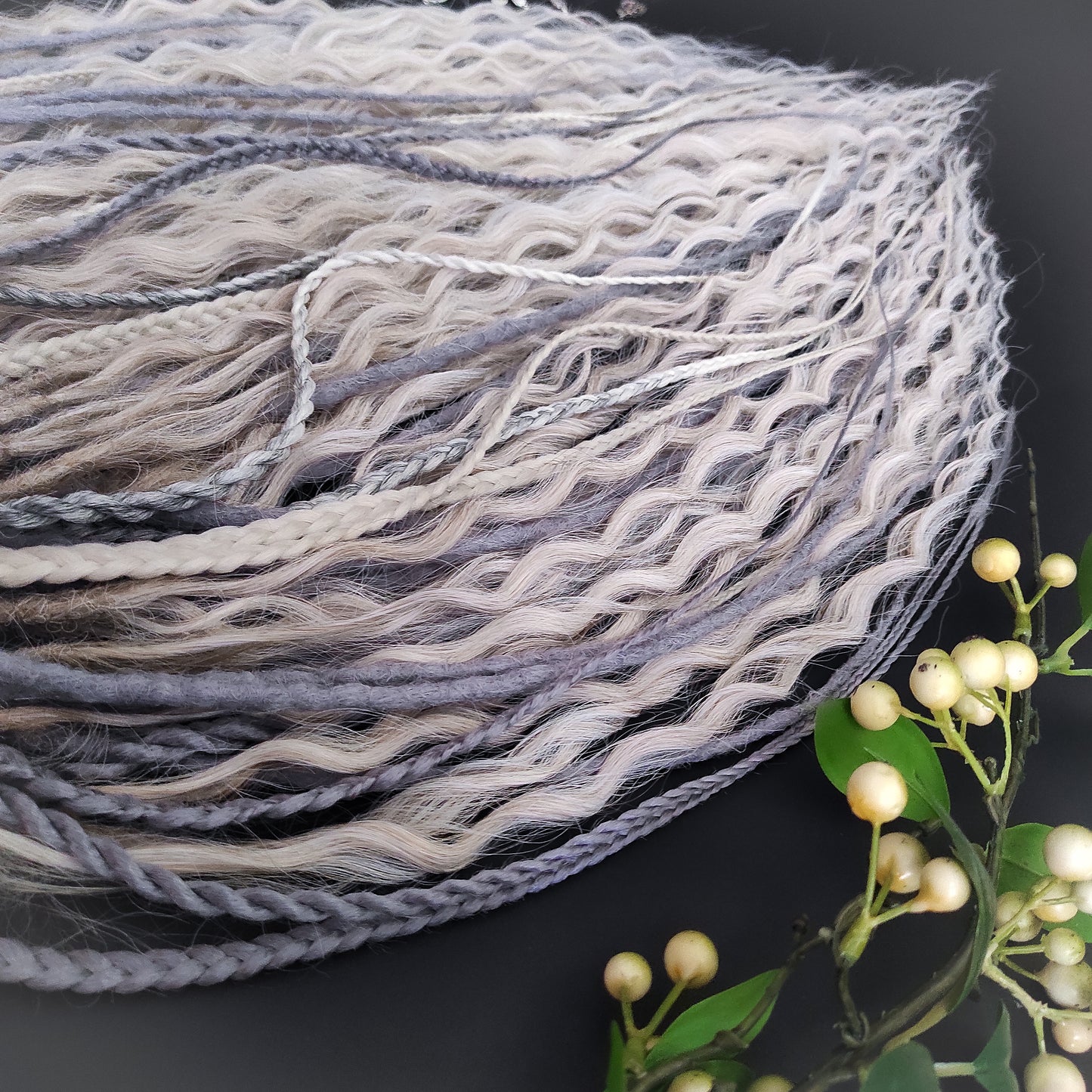 A mix of silver, grey and blonde - lightweight,  reusable synthetic double ended crochet dreadlocks, non-brushable dreaded curls, braids, and Senegalese twists.

Standard length: ±22-24 inches (55-60 cm)
Thickness of dreads and braids: ±0.8 cm
Dreaded part of curls ±10-12 cm (4-5 inches)