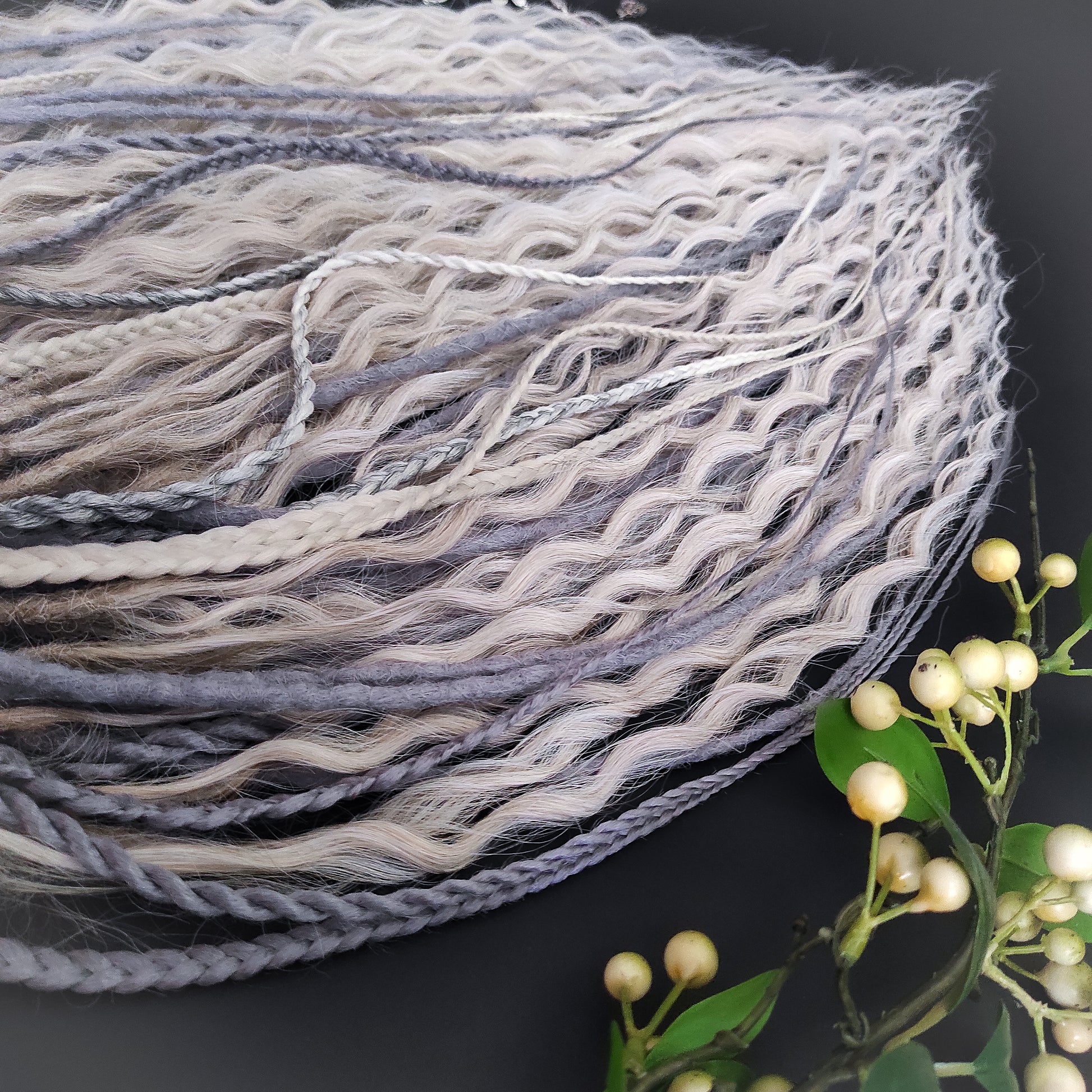 A mix of silver, grey and blonde - lightweight,  reusable synthetic double ended crochet dreadlocks, non-brushable dreaded curls, braids, and Senegalese twists.

Standard length: ±22-24 inches (55-60 cm)
Thickness of dreads and braids: ±0.8 cm
Dreaded part of curls ±10-12 cm (4-5 inches)