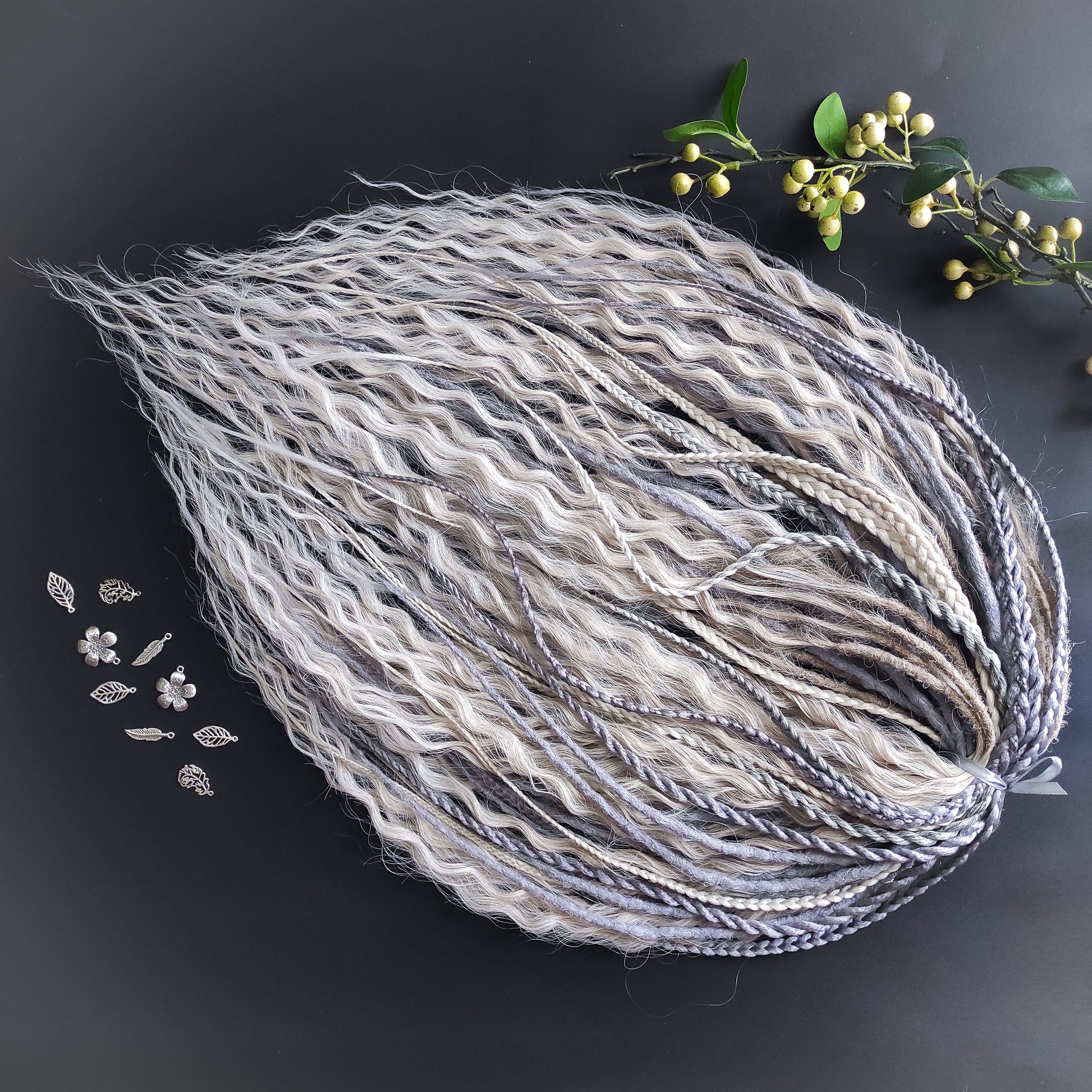 A mix of silver, grey and blonde - lightweight,  reusable synthetic double ended crochet dreadlocks, non-brushable dreaded curls, braids, and Senegalese twists.

Standard length: ±22-24 inches (55-60 cm)
Thickness of dreads and braids: ±0.8 cm
Dreaded part of curls ±10-12 cm (4-5 inches)