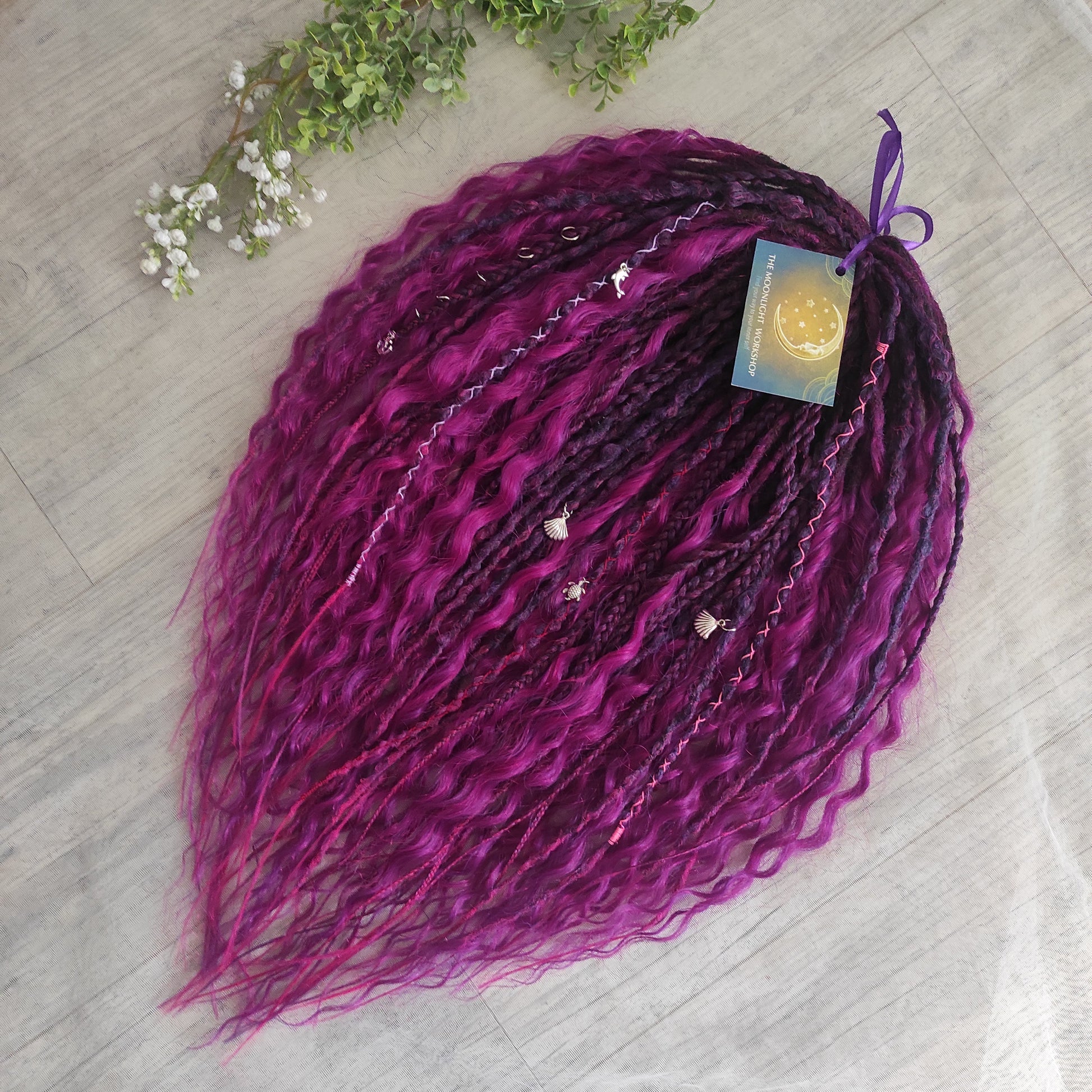 A rich, saturated magenta shade with deep berry and purple undertones. The color shifts between dark fuchsia, plum, and wine tones, creating depth and dimension throughout the set.  Soft, lightweight, and reusable double ended braids, Senegalese twists, and non-brushable dreaded curls.

Standard length: ±22-24 inches (55-60 cm)
Thickness of dreads and braids: ±0.8 cm
Dreaded part of curls ±8-10 cm (3-4 inches)