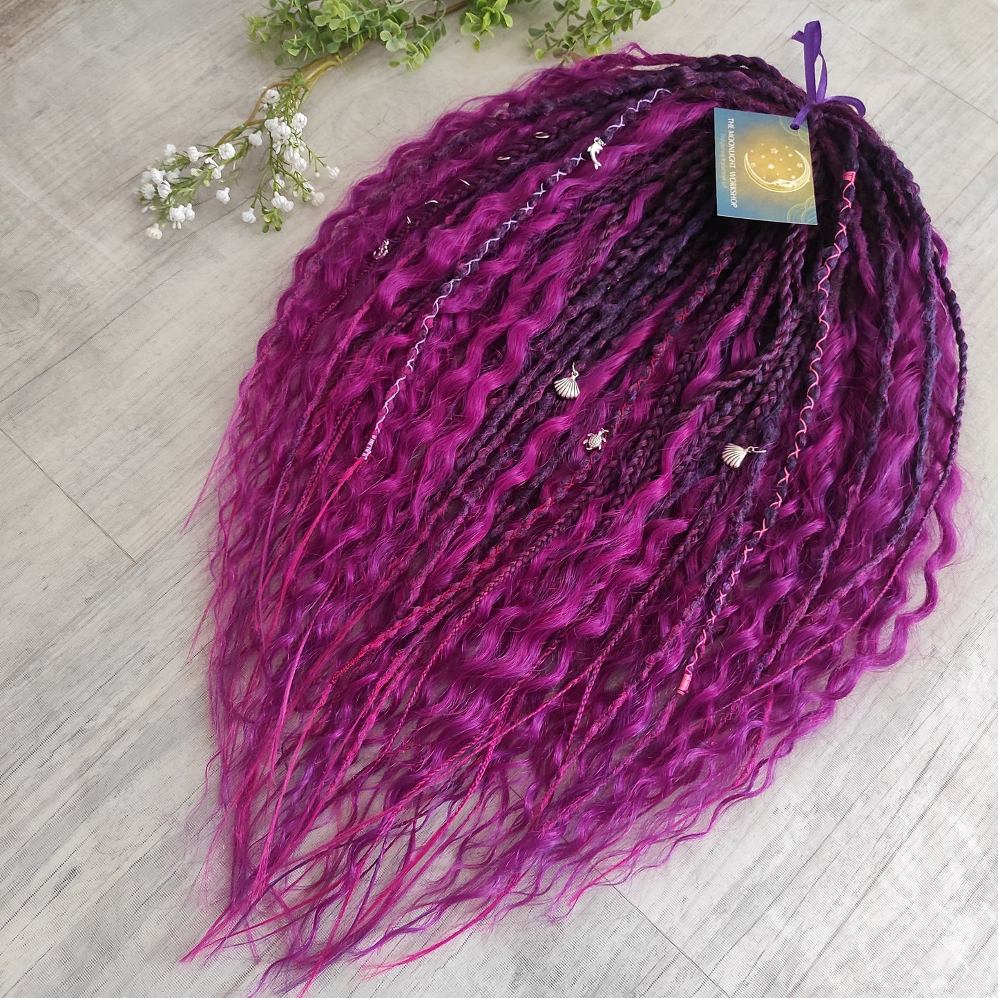 A rich, saturated magenta shade with deep berry and purple undertones. The color shifts between dark fuchsia, plum, and wine tones, creating depth and dimension throughout the set.  Soft, lightweight, and reusable double ended braids, Senegalese twists, and non-brushable dreaded curls.

Standard length: ±22-24 inches (55-60 cm)
Thickness of dreads and braids: ±0.8 cm
Dreaded part of curls ±8-10 cm (3-4 inches)
