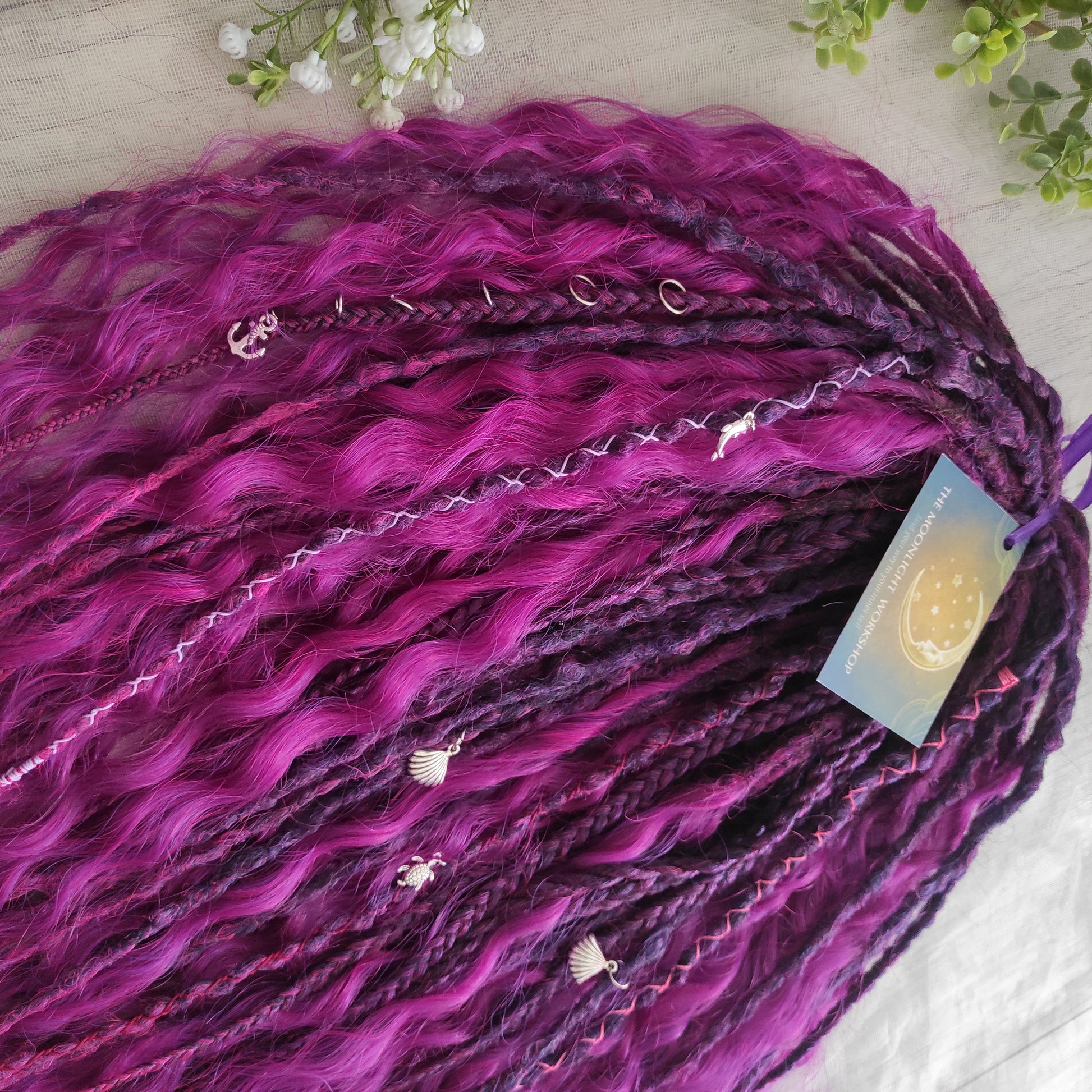 A rich, saturated magenta shade with deep berry and purple undertones. The color shifts between dark fuchsia, plum, and wine tones, creating depth and dimension throughout the set.  Soft, lightweight, and reusable double ended braids, Senegalese twists, and non-brushable dreaded curls.

Standard length: ±22-24 inches (55-60 cm)
Thickness of dreads and braids: ±0.8 cm
Dreaded part of curls ±8-10 cm (3-4 inches)
