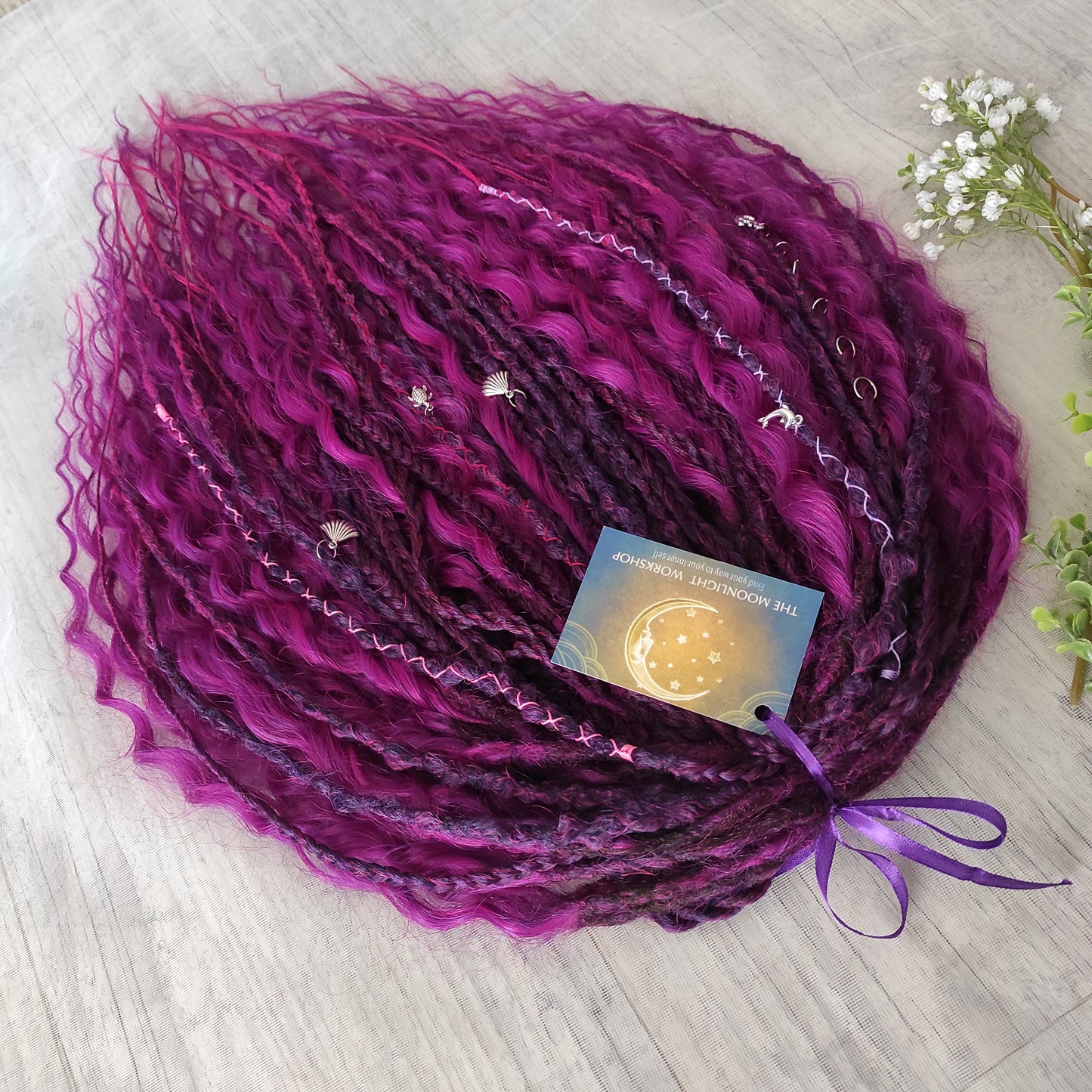 A rich, saturated magenta shade with deep berry and purple undertones. The color shifts between dark fuchsia, plum, and wine tones, creating depth and dimension throughout the set.  Soft, lightweight, and reusable double ended braids, Senegalese twists, and non-brushable dreaded curls.

Standard length: ±22-24 inches (55-60 cm)
Thickness of dreads and braids: ±0.8 cm
Dreaded part of curls ±8-10 cm (3-4 inches)