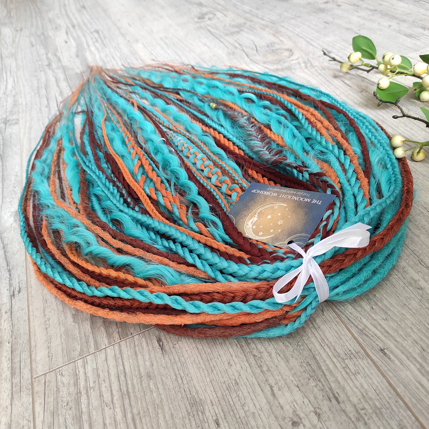 Ginger Sky: soft, lightweight, and reusable double ended synthetic dreads, braids, and regular dreaded non-brushable curls. A mix of turquoise green, red, copper, and orange colours.

The length is 22-24 inches (55-60 cm)
Dreaded part of curls: 3-4 inches
Thickness of dreads and braids ±0.8 cm