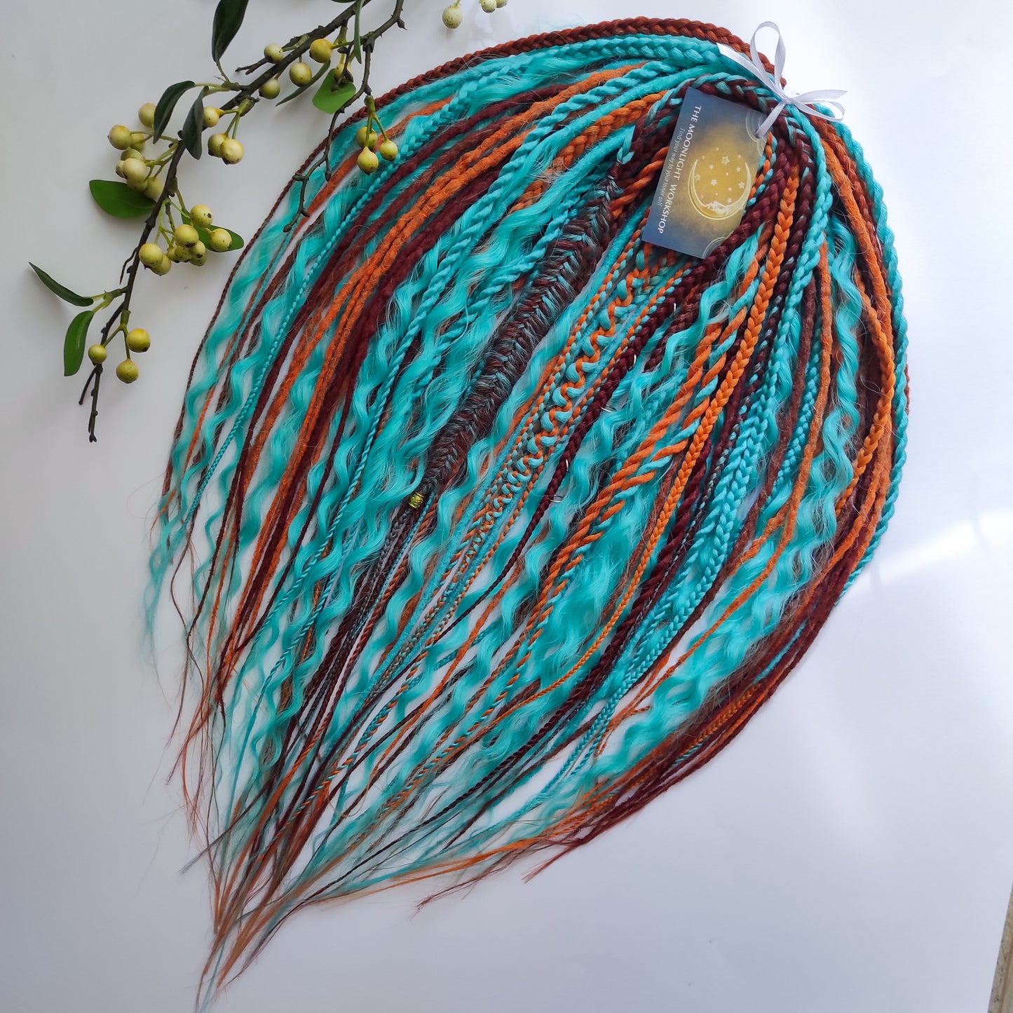 Ginger Sky: soft, lightweight, and reusable double ended synthetic dreads, braids, and regular dreaded non-brushable curls. A mix of turquoise green, red, copper, and orange colours.

The length is 22-24 inches (55-60 cm)
Dreaded part of curls: 3-4 inches
Thickness of dreads and braids ±0.8 cm