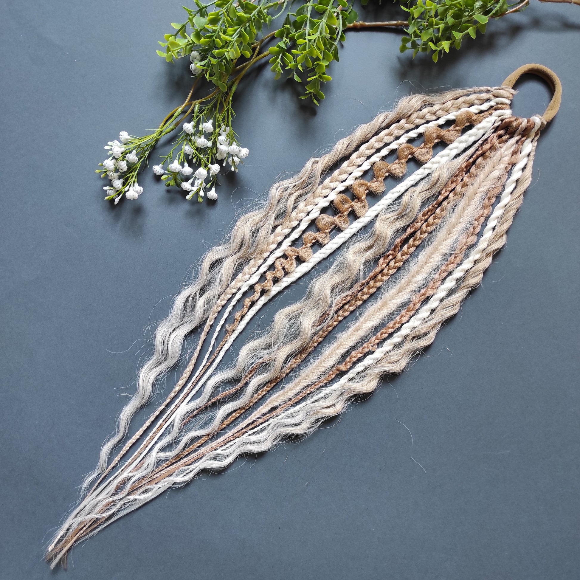 Braids, dreads, and curls on an elastic band — a simple way to transform a ponytail without installing a set. Easy to put on and remove whenever you like. A great option if you can’t install dreads or braids. Also, a perfect gift for kids 🎁

These scrunchies add instant length, volume, and texture — whether you prefer bold colors or natural shades.

Length: 22–24 inches.
Each hair tie includes 12–14 pieces, depending on the style.

Choose from the available designs shown, or contact us for a custom order.
