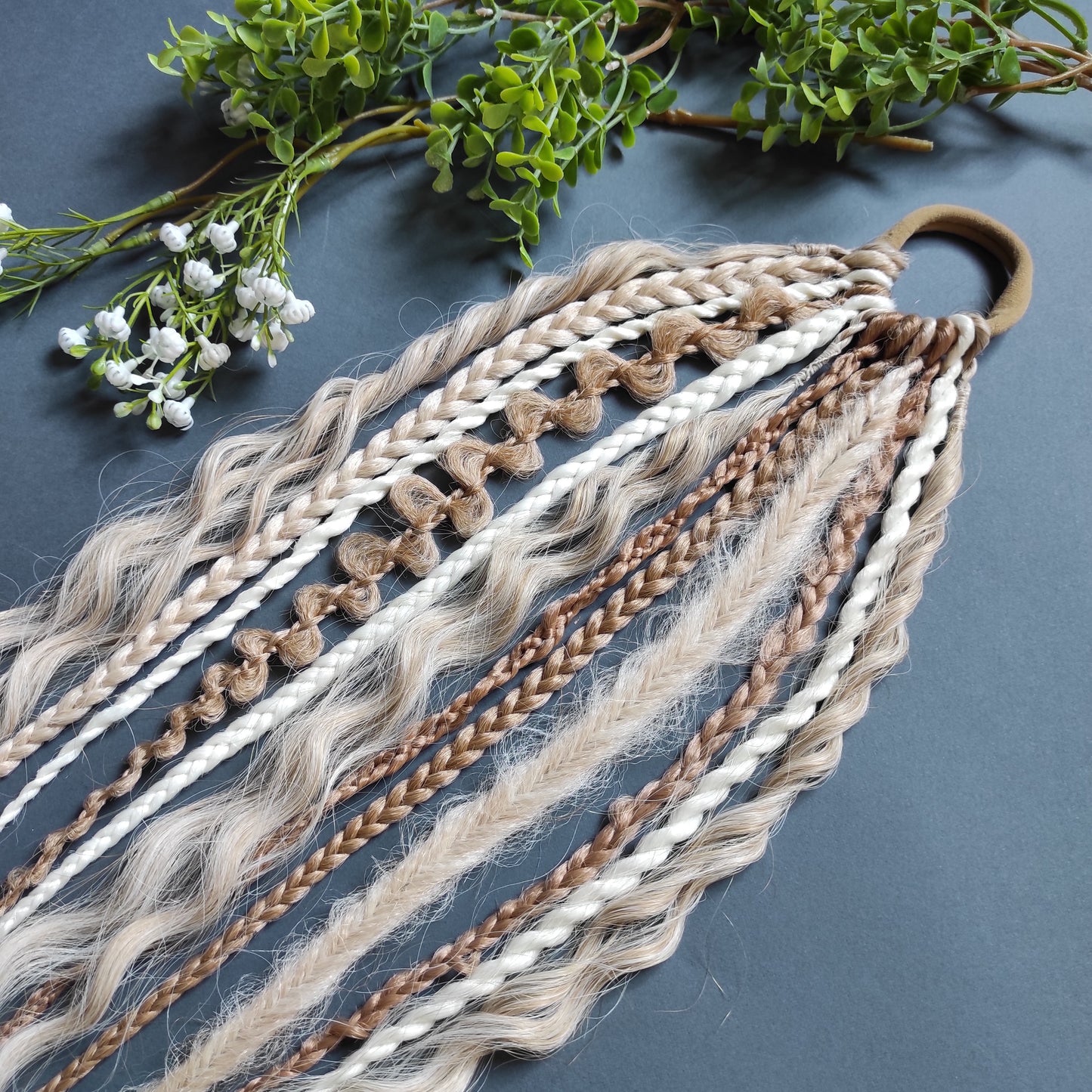 Braids, dreads, and curls on an elastic band — a simple way to transform a ponytail without installing a set. Easy to put on and remove whenever you like. A great option if you can’t install dreads or braids. Also, a perfect gift for kids 🎁

These scrunchies add instant length, volume, and texture — whether you prefer bold colors or natural shades.

Length: 22–24 inches.
Each hair tie includes 12–14 pieces, depending on the style.

Choose from the available designs shown, or contact us for a custom order.