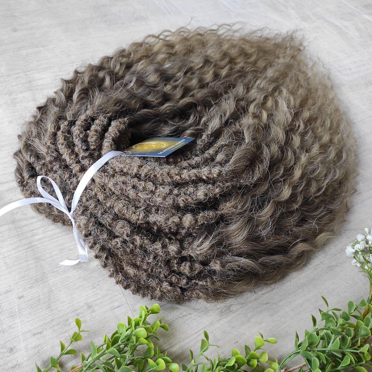 Ash ombre from light brown to wheat blonde (the color may look a bit different in different lighting). Soft, lightweight, and reusable synthetic brushable double ended wavy dreadlocks