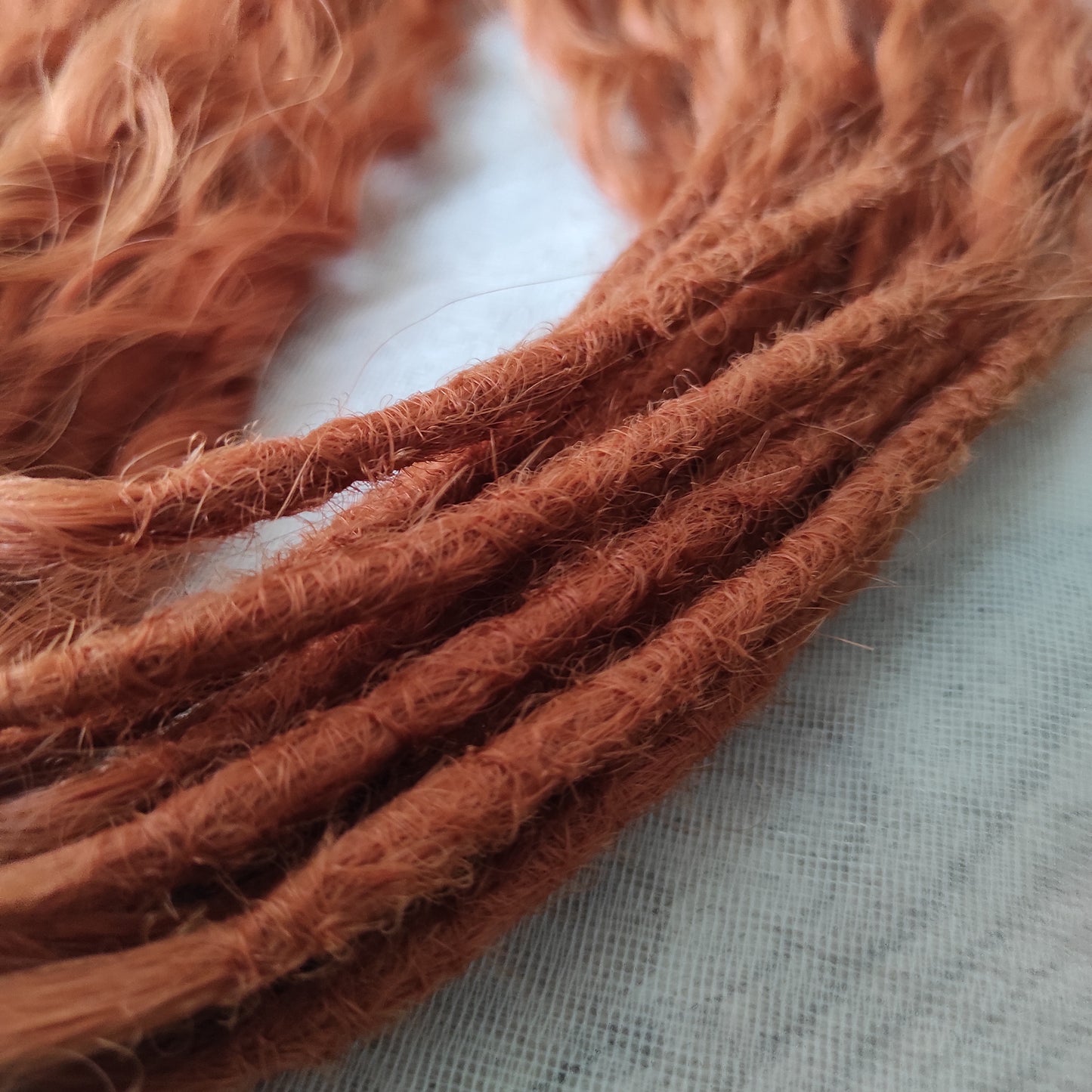 Soft, lightweight, and reusable synthetic sets of double ended regular curls (NOT BRUSHABLE) in red shades:

1. copper;
2. auburn/bronze;