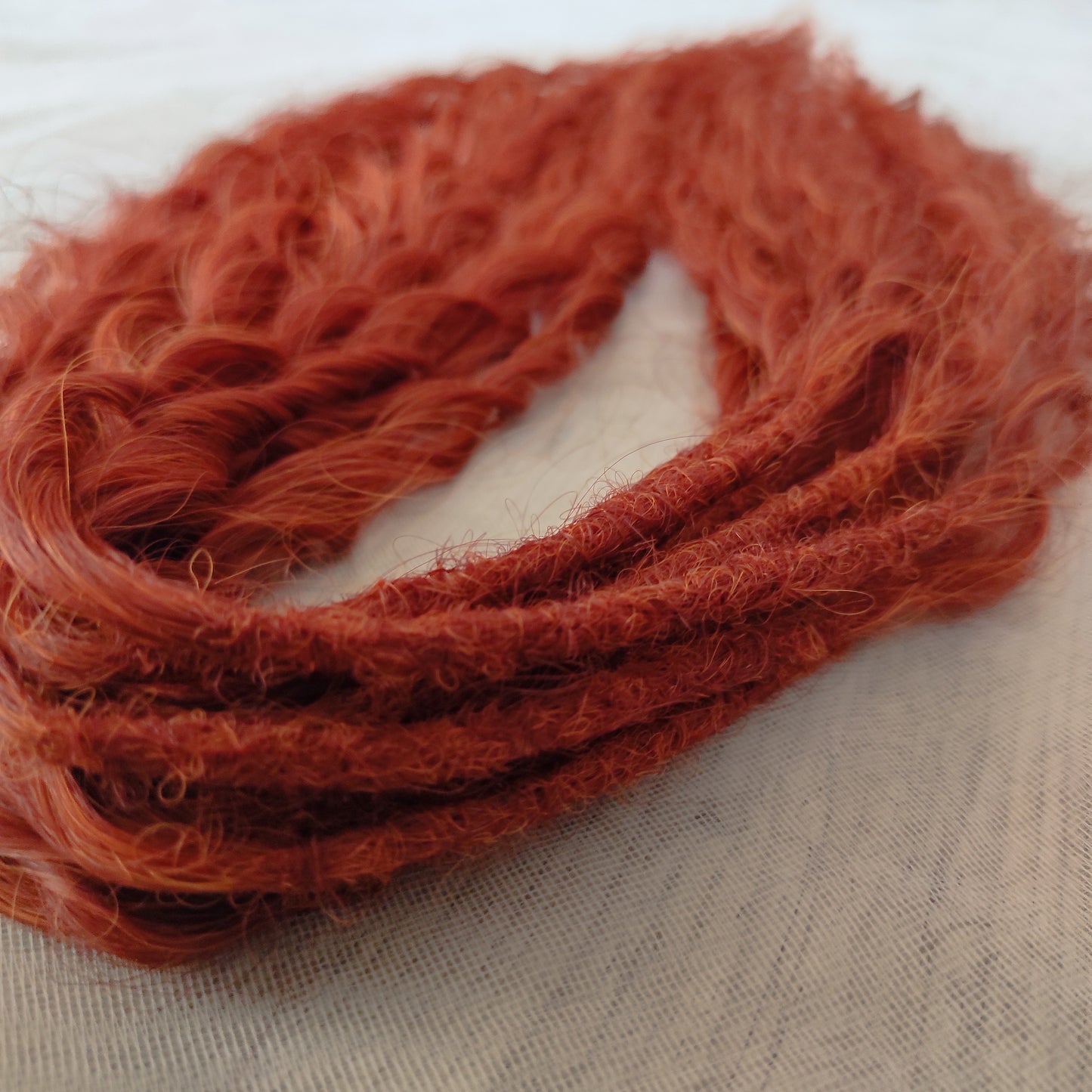 Soft, lightweight, and reusable synthetic sets of double ended regular curls (NOT BRUSHABLE) in red shades:

1. copper;
2. auburn/bronze;