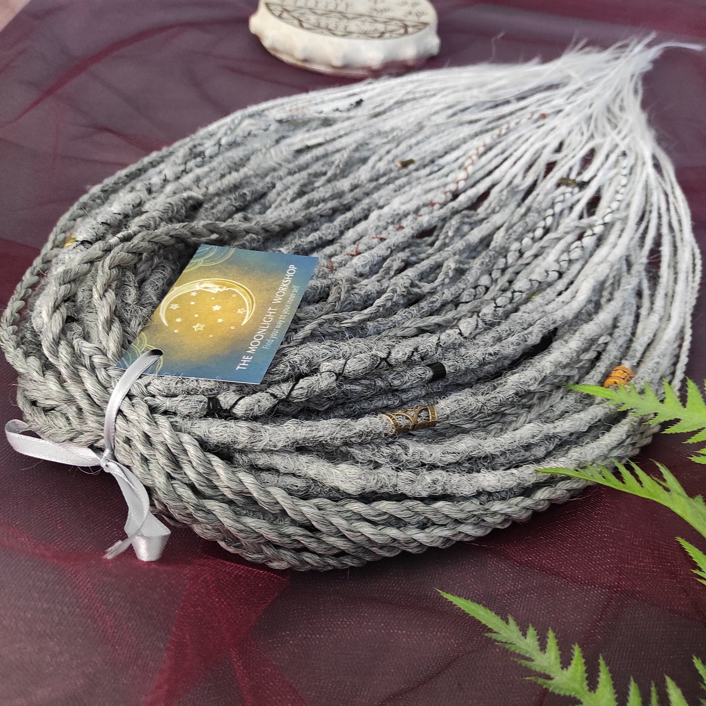 This set of synthetic dreadlocks combines elements of a Viking-inspired aesthetic.
Ombre from grey to platinum blonde double ended crochet dreads, braids, and Senegalese twists. Decoration is included. Reusable lightweight set made from high-quality synthetic hypoallergenic material kanekalon.

Standard length: ±22-24 inches (55-60 cm)
Thickness of dreads and braids: ±0.8 cm
