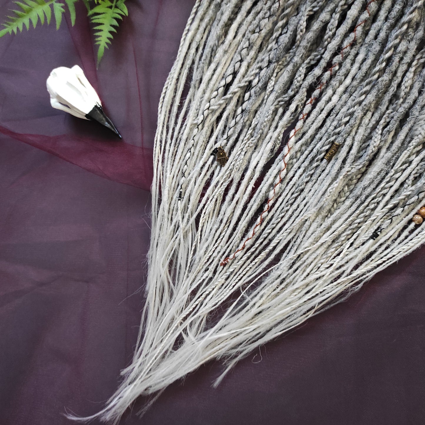 This set of synthetic dreadlocks combines elements of a Viking-inspired aesthetic.
Ombre from grey to platinum blonde double ended crochet dreads, braids, and Senegalese twists. Decoration is included. Reusable lightweight set made from high-quality synthetic hypoallergenic material kanekalon.

Standard length: ±22-24 inches (55-60 cm)
Thickness of dreads and braids: ±0.8 cm
