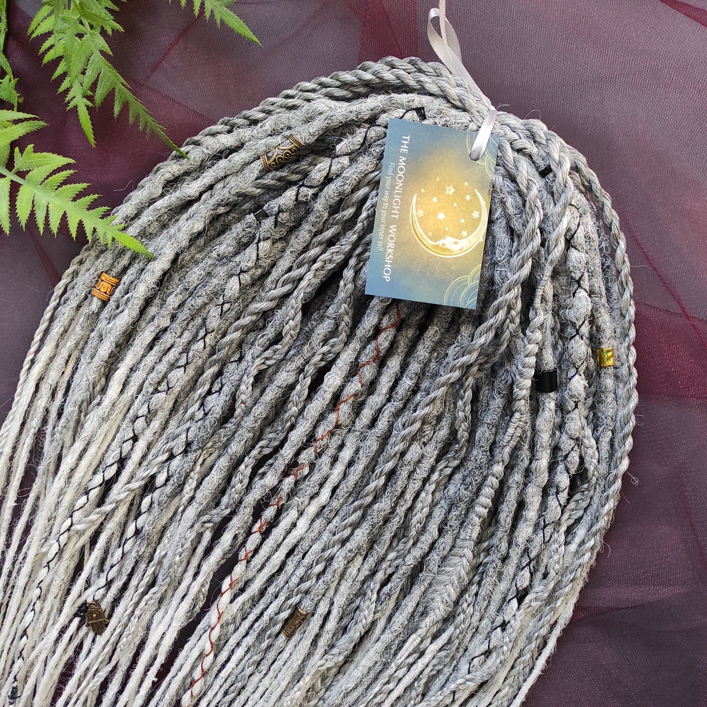 This set of synthetic dreadlocks combines elements of a Viking-inspired aesthetic.
Ombre from grey to platinum blonde double ended crochet dreads, braids, and Senegalese twists. Decoration is included. Reusable lightweight set made from high-quality synthetic hypoallergenic material kanekalon.

Standard length: ±22-24 inches (55-60 cm)
Thickness of dreads and braids: ±0.8 cm
