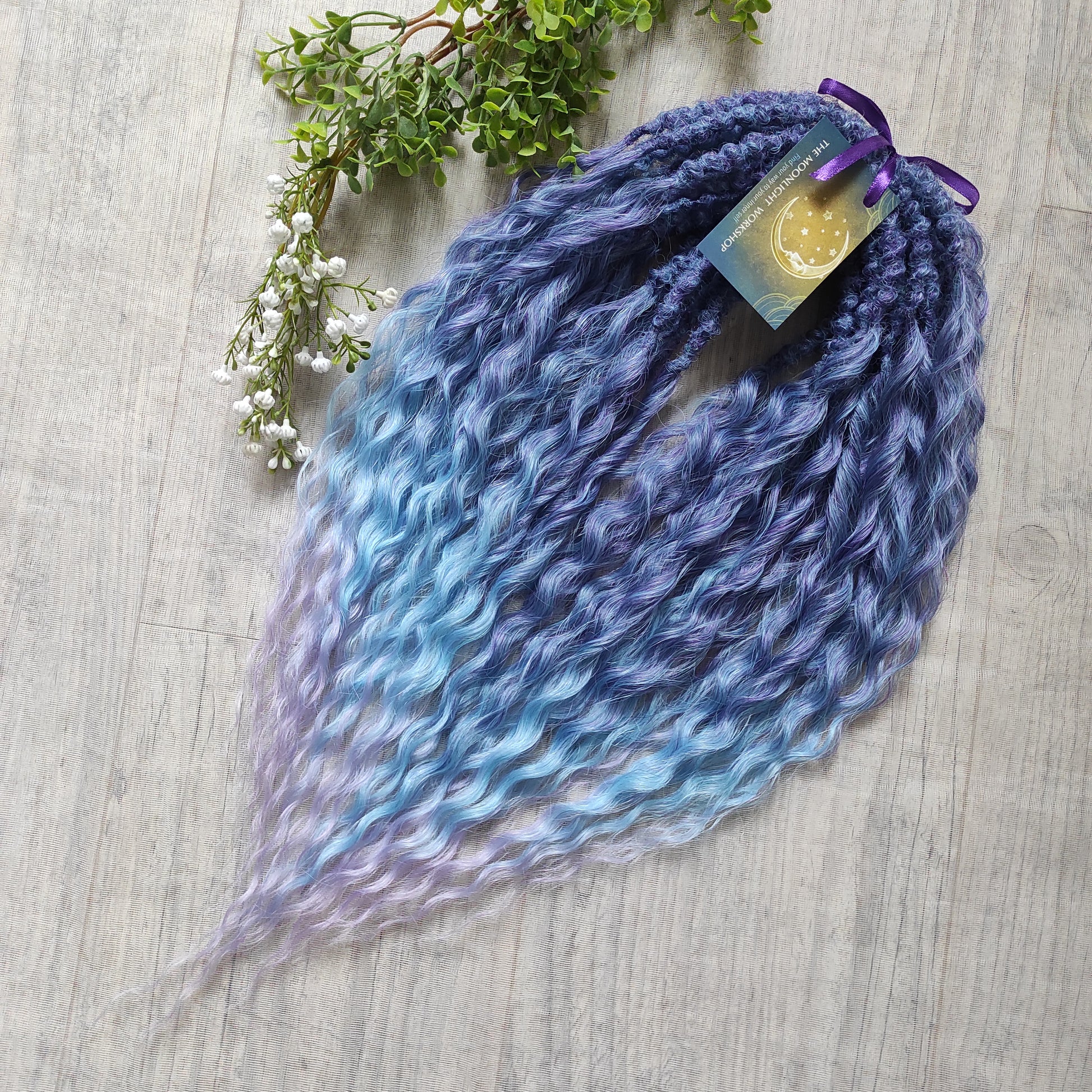Soft, lightweight, and reusable synthetic sets of double ended regular curls (NOT BRUSHABLE) in blue and purple shades: ombre from indigo to sky blue and lavender.