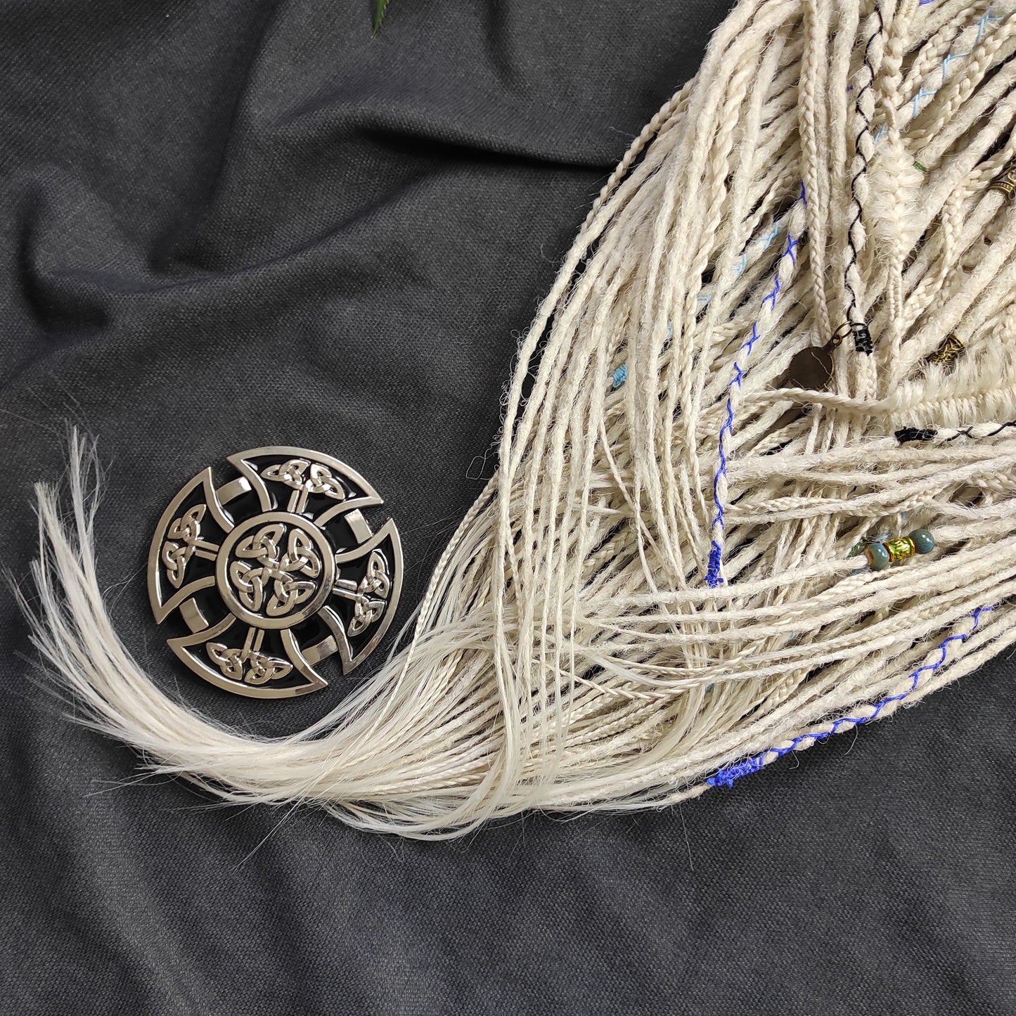 This set of synthetic dreadlocks combines elements of a Viking-inspired aesthetic.
Scandinavian blonde double ended crochet bumpy dreads, braids, and Senegalese twists. Decoration is included. Reusable lightweight set made from high-quality synthetic hypoallergenic material kanekalon.

Standard length: ±22-24 inches (55-60 cm)
Thickness of dreads and braids: ±0.8 cm