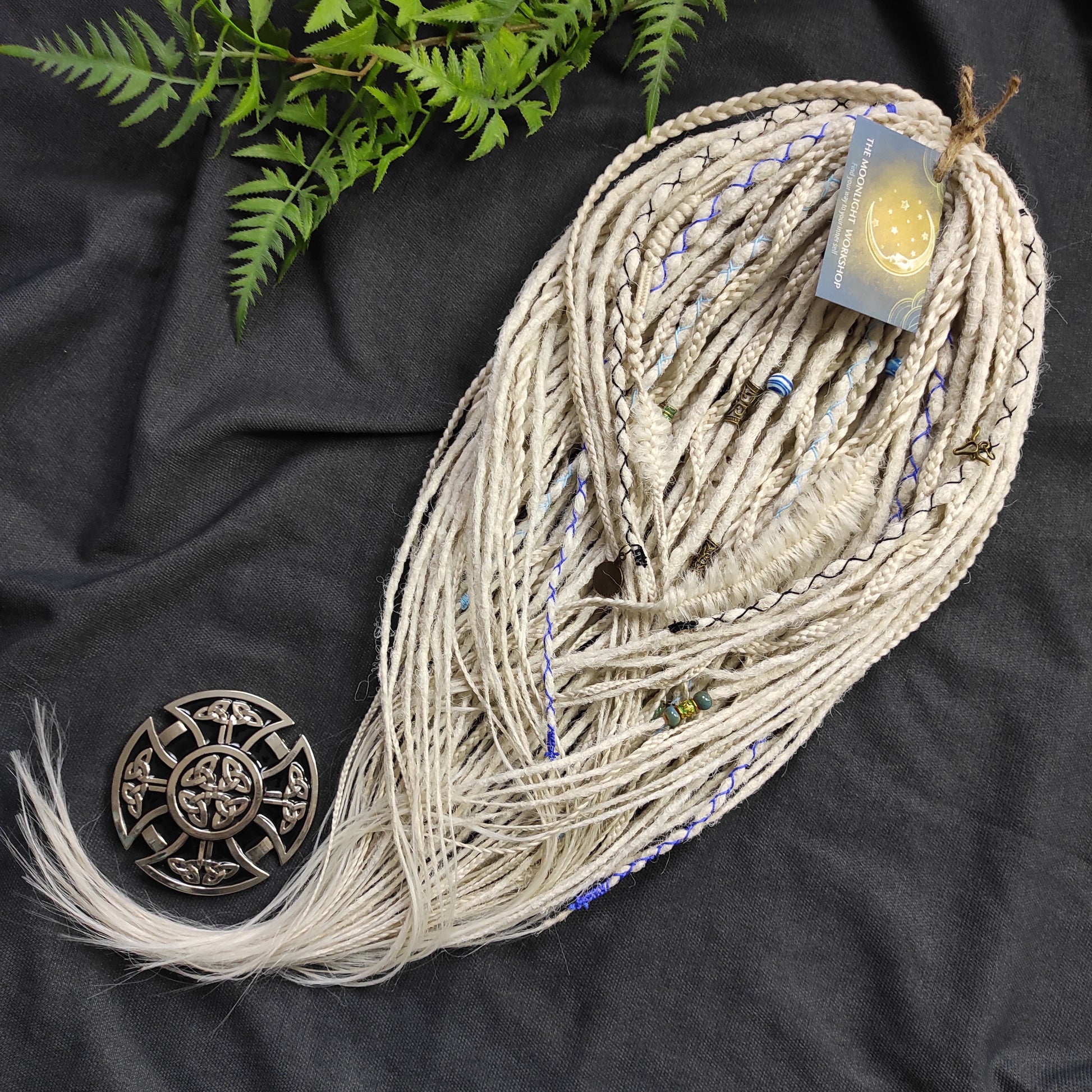 This set of synthetic dreadlocks combines elements of a Viking-inspired aesthetic.
Scandinavian blonde double ended crochet bumpy dreads, braids, and Senegalese twists. Decoration is included. Reusable lightweight set made from high-quality synthetic hypoallergenic material kanekalon.

Standard length: ±22-24 inches (55-60 cm)
Thickness of dreads and braids: ±0.8 cm