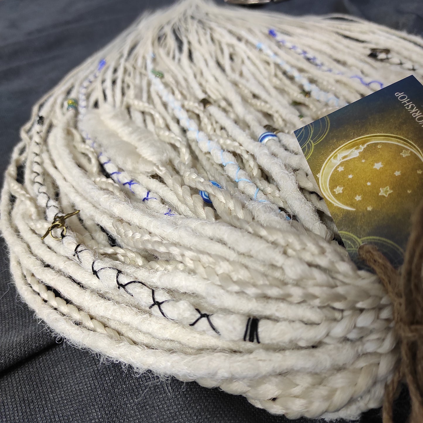 This set of synthetic dreadlocks combines elements of a Viking-inspired aesthetic.
Scandinavian blonde double ended crochet bumpy dreads, braids, and Senegalese twists. Decoration is included. Reusable lightweight set made from high-quality synthetic hypoallergenic material kanekalon.

Standard length: ±22-24 inches (55-60 cm)
Thickness of dreads and braids: ±0.8 cm