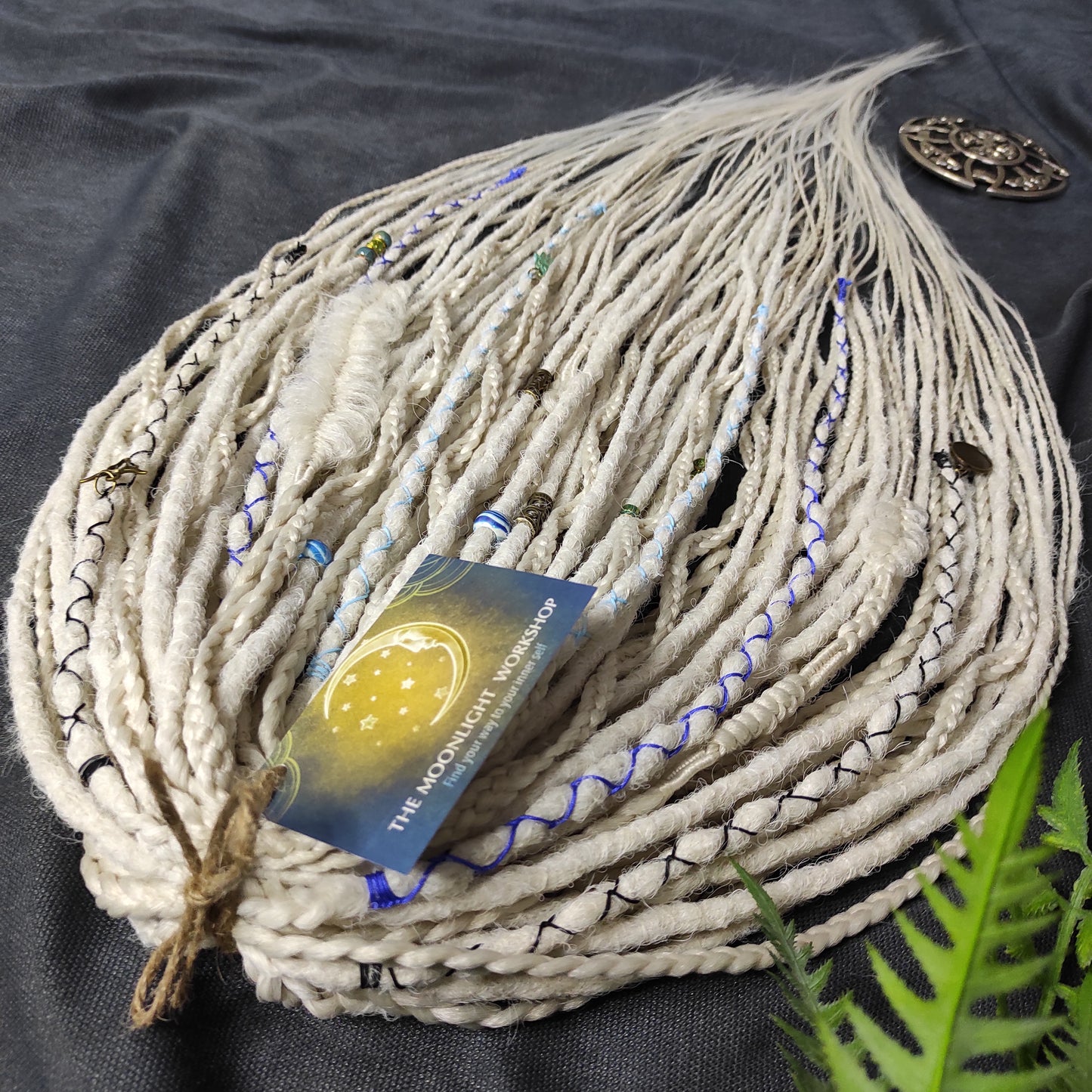 This set of synthetic dreadlocks combines elements of a Viking-inspired aesthetic.
Scandinavian blonde double ended crochet bumpy dreads, braids, and Senegalese twists. Decoration is included. Reusable lightweight set made from high-quality synthetic hypoallergenic material kanekalon.

Standard length: ±22-24 inches (55-60 cm)
Thickness of dreads and braids: ±0.8 cm