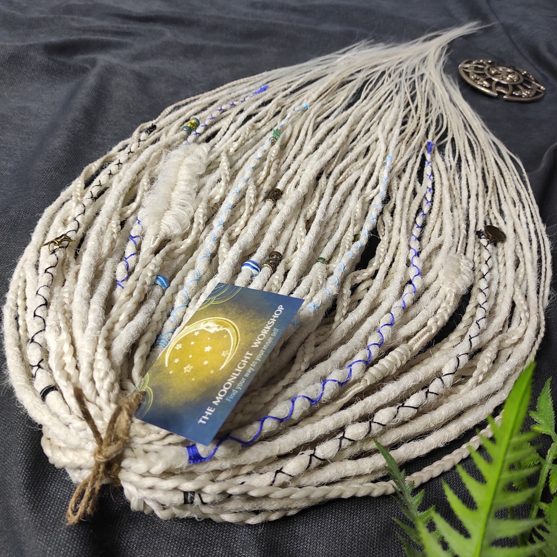 This set of synthetic dreadlocks combines elements of a Viking-inspired aesthetic.
Scandinavian blonde double ended crochet bumpy dreads, braids, and Senegalese twists. Decoration is included. Reusable lightweight set made from high-quality synthetic hypoallergenic material kanekalon.

Standard length: ±22-24 inches (55-60 cm)
Thickness of dreads and braids: ±0.8 cm