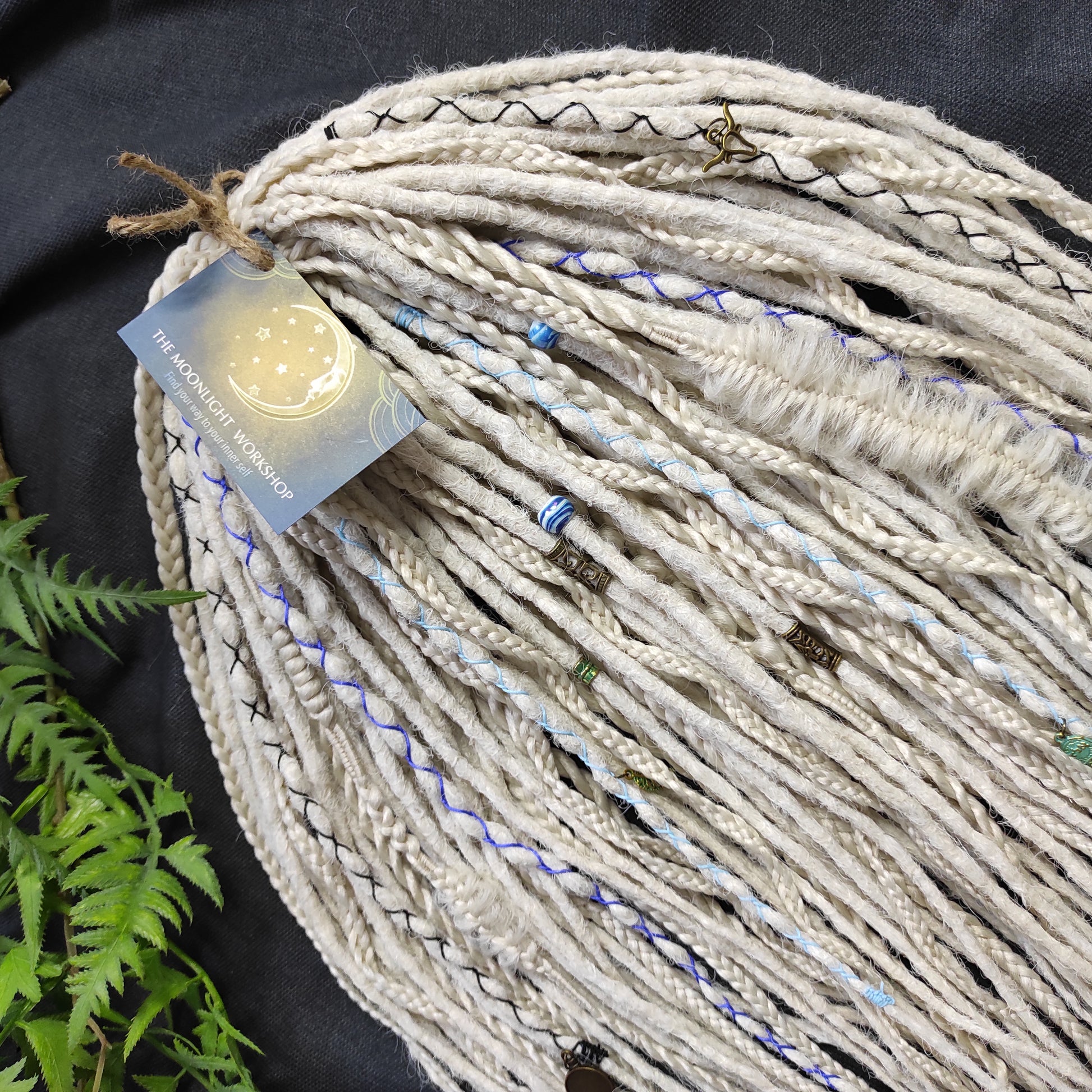 This set of synthetic dreadlocks combines elements of a Viking-inspired aesthetic.
Scandinavian blonde double ended crochet bumpy dreads, braids, and Senegalese twists. Decoration is included. Reusable lightweight set made from high-quality synthetic hypoallergenic material kanekalon.

Standard length: ±22-24 inches (55-60 cm)
Thickness of dreads and braids: ±0.8 cm