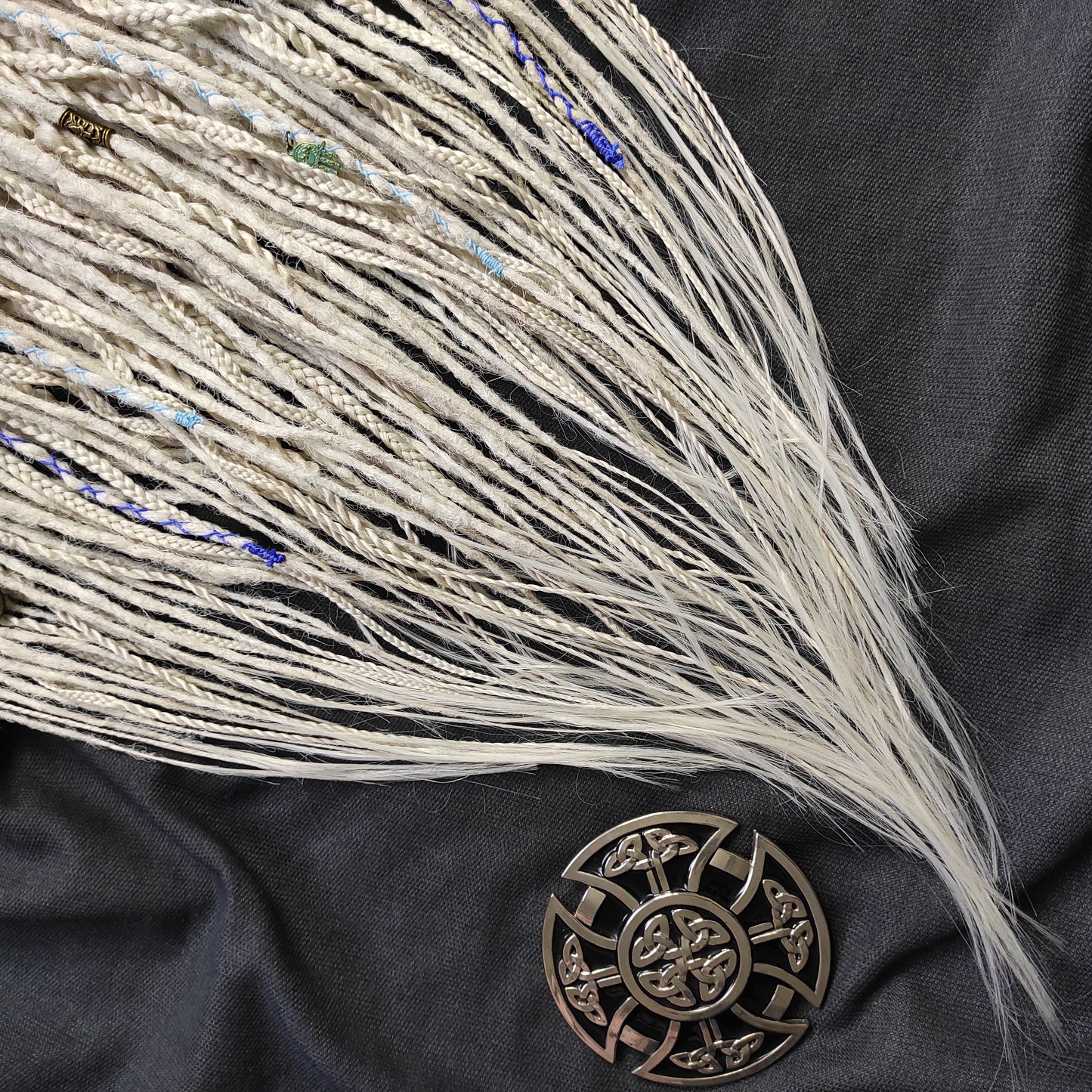 This set of synthetic dreadlocks combines elements of a Viking-inspired aesthetic.
Scandinavian blonde double ended crochet bumpy dreads, braids, and Senegalese twists. Decoration is included. Reusable lightweight set made from high-quality synthetic hypoallergenic material kanekalon.

Standard length: ±22-24 inches (55-60 cm)
Thickness of dreads and braids: ±0.8 cm