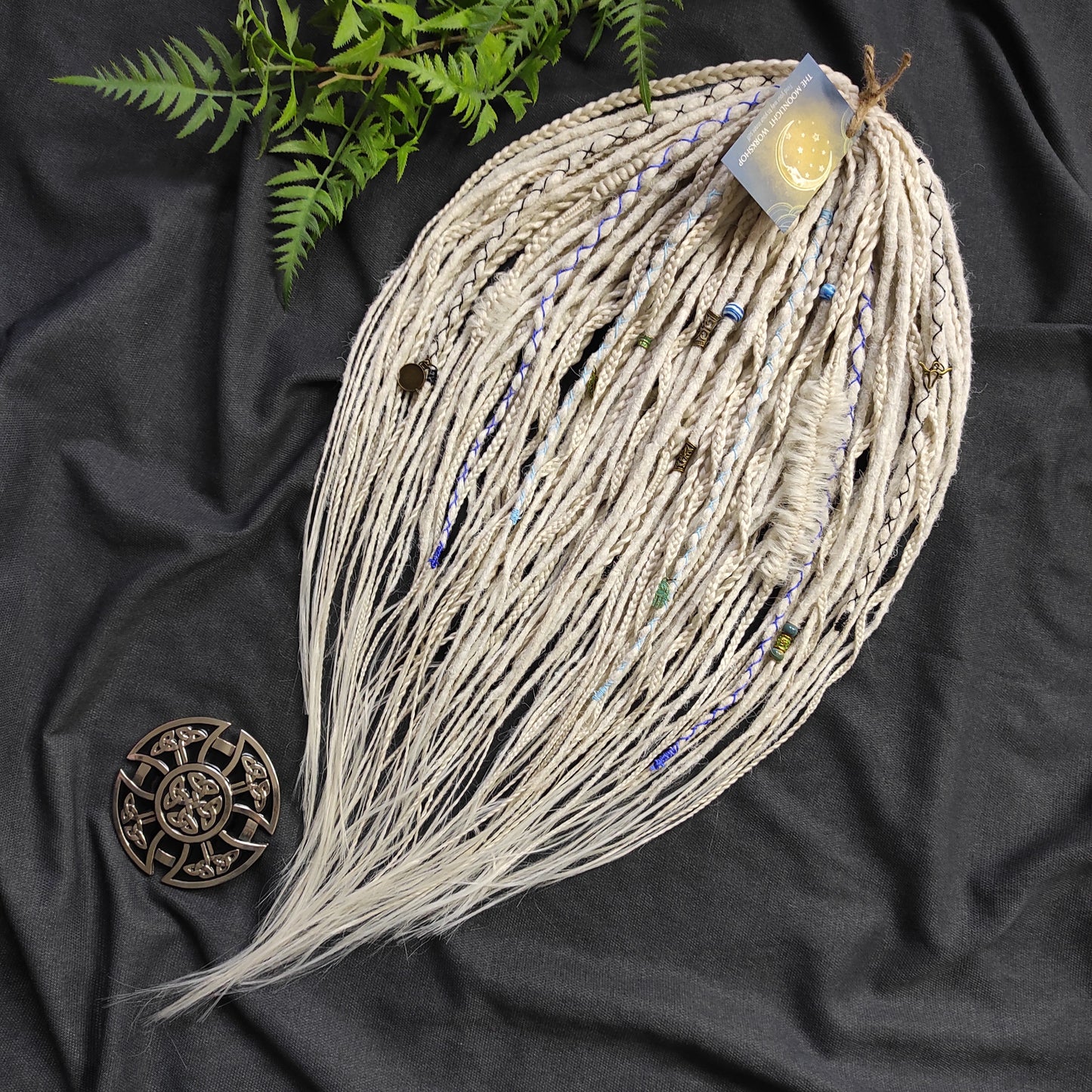 This set of synthetic dreadlocks combines elements of a Viking-inspired aesthetic.
Scandinavian blonde double ended crochet bumpy dreads, braids, and Senegalese twists. Decoration is included. Reusable lightweight set made from high-quality synthetic hypoallergenic material kanekalon.

Standard length: ±22-24 inches (55-60 cm)
Thickness of dreads and braids: ±0.8 cm