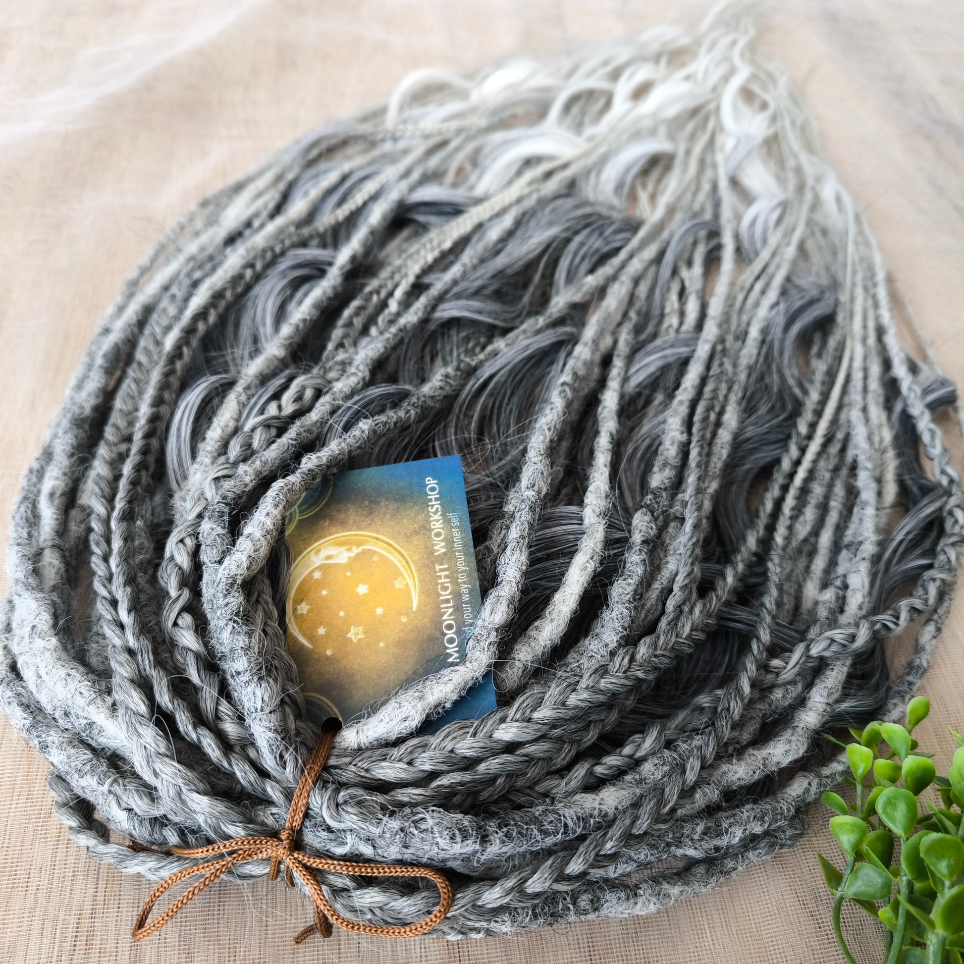 This set of synthetic dreadlocks combines elements of a Viking-inspired aesthetic.
Ombre from grey to platinum blonde double ended crochet dreads, braids, and Senegalese twists (curls optionally). Decoration is included. Reusable lightweight set made from high-quality synthetic hypoallergenic material kanekalon.

Standard length: ±22-24 inches (55-60 cm)
Thickness of dreads and braids: ±0.8 cm
Dreaded part of curls: ±3-4 inches (8-10 cm)
