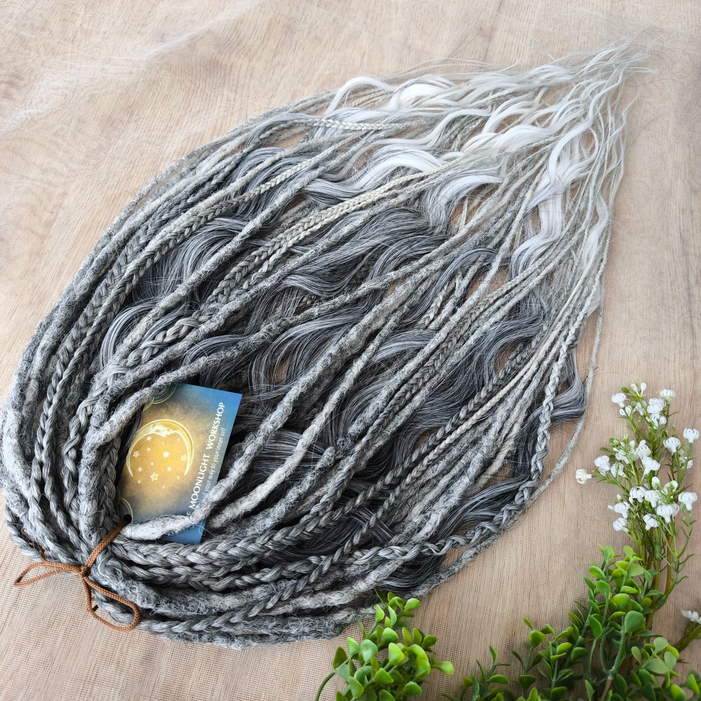 This set of synthetic dreadlocks combines elements of a Viking-inspired aesthetic.
Ombre from grey to platinum blonde double ended crochet dreads, braids, and Senegalese twists (curls optionally). Decoration is included. Reusable lightweight set made from high-quality synthetic hypoallergenic material kanekalon.

Standard length: ±22-24 inches (55-60 cm)
Thickness of dreads and braids: ±0.8 cm
Dreaded part of curls: ±3-4 inches (8-10 cm)