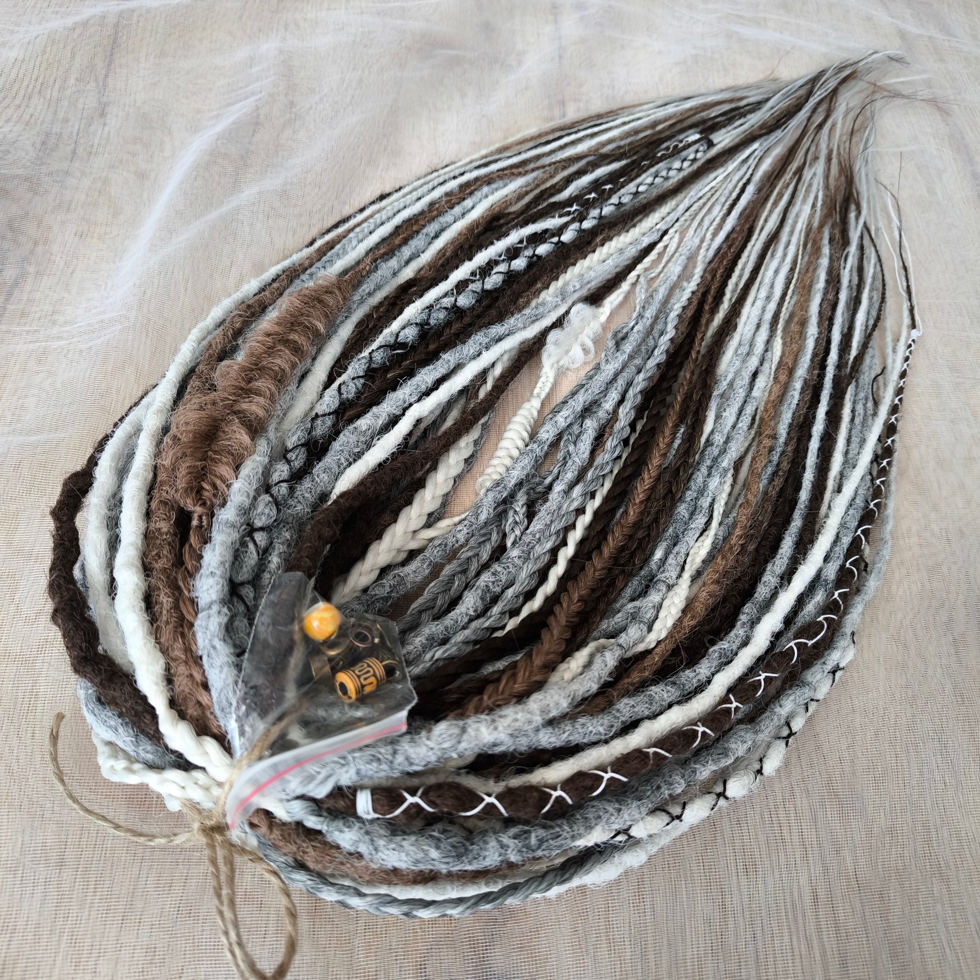 Stonewood - crochet dreads and braids in white, ombre from grey to ash blonde and brown tones.

Length - 22-24 inches (55-60 cm)
Thickness of the dreads and braids - ±0.8-1 cm