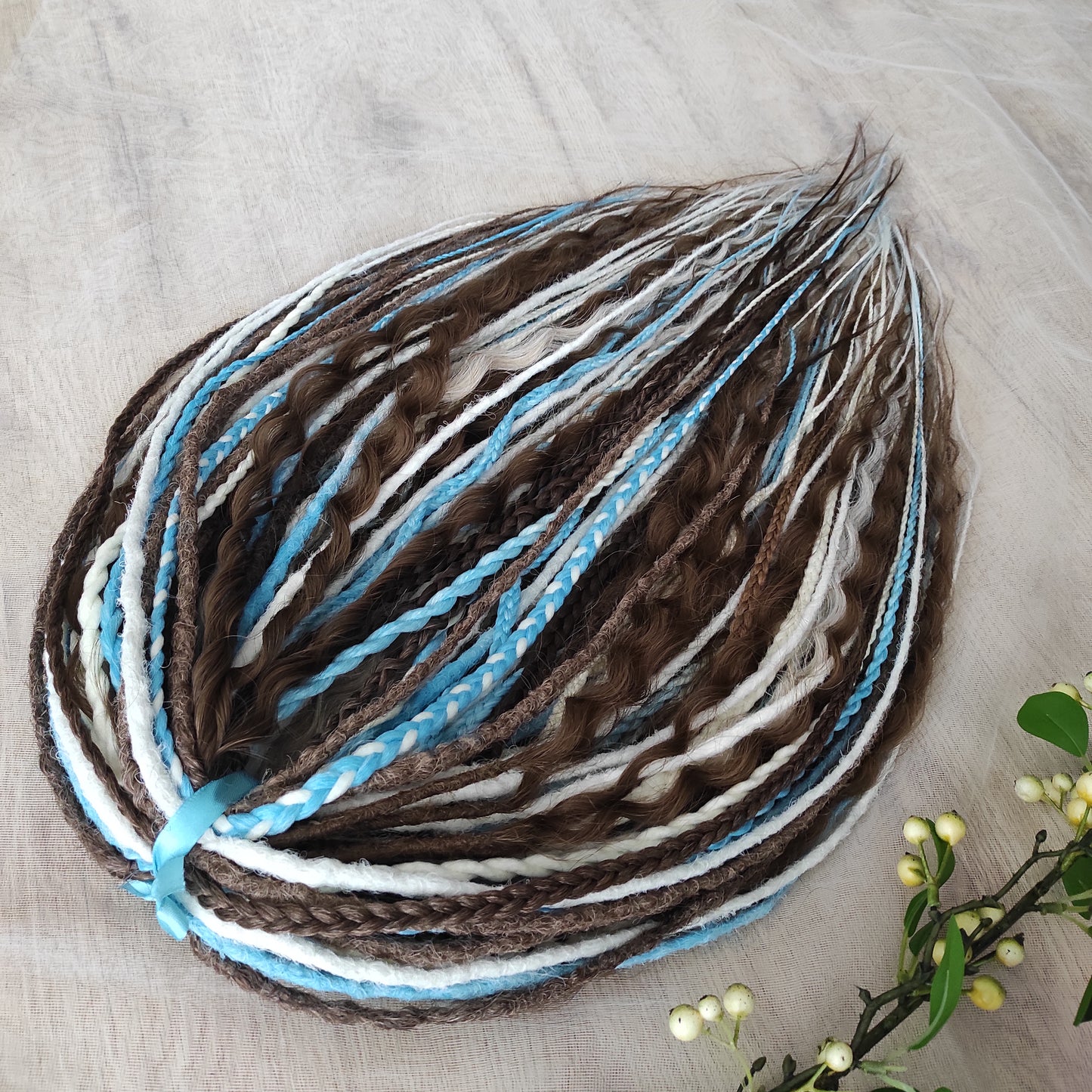 A calm mix of cocoa brown, creamy blonde, and bright blue accents — lightweight, brushable, and reusable synthetic DE curls and braids.