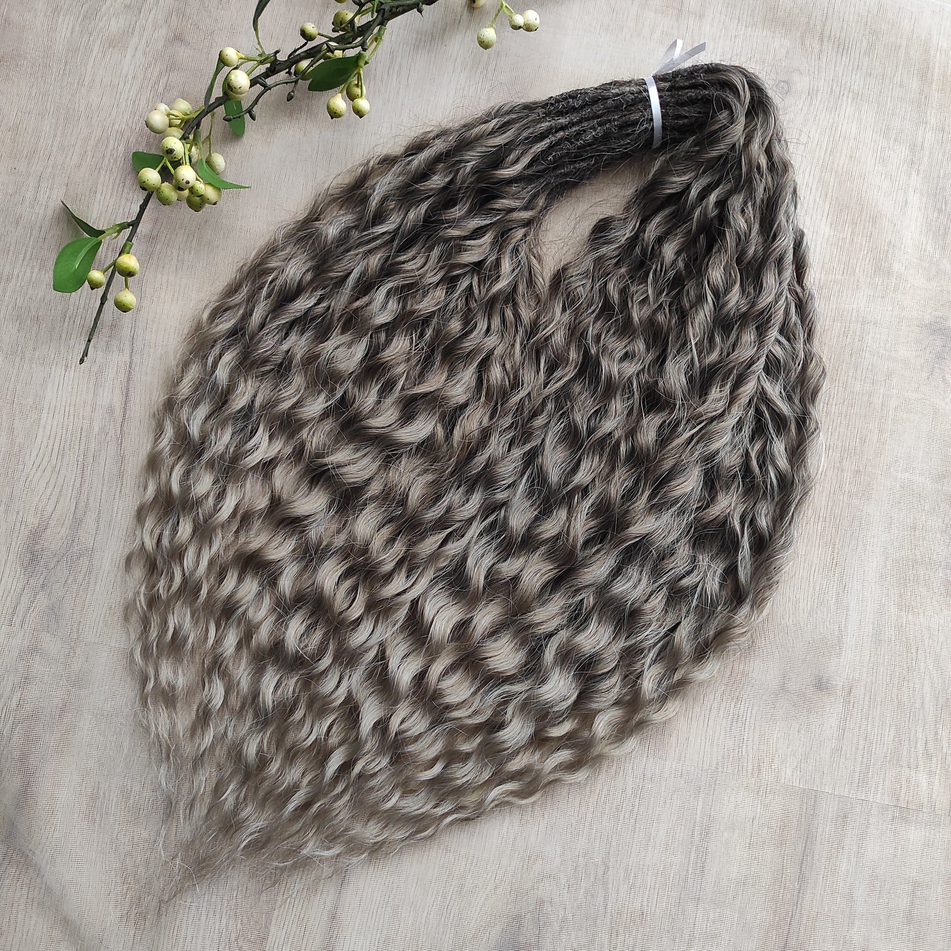 Ash ombre from light brown to wheat blonde (the color may look a bit different in different lighting). Soft, lightweight, and reusable synthetic brushable double ended wavy dreadlocks