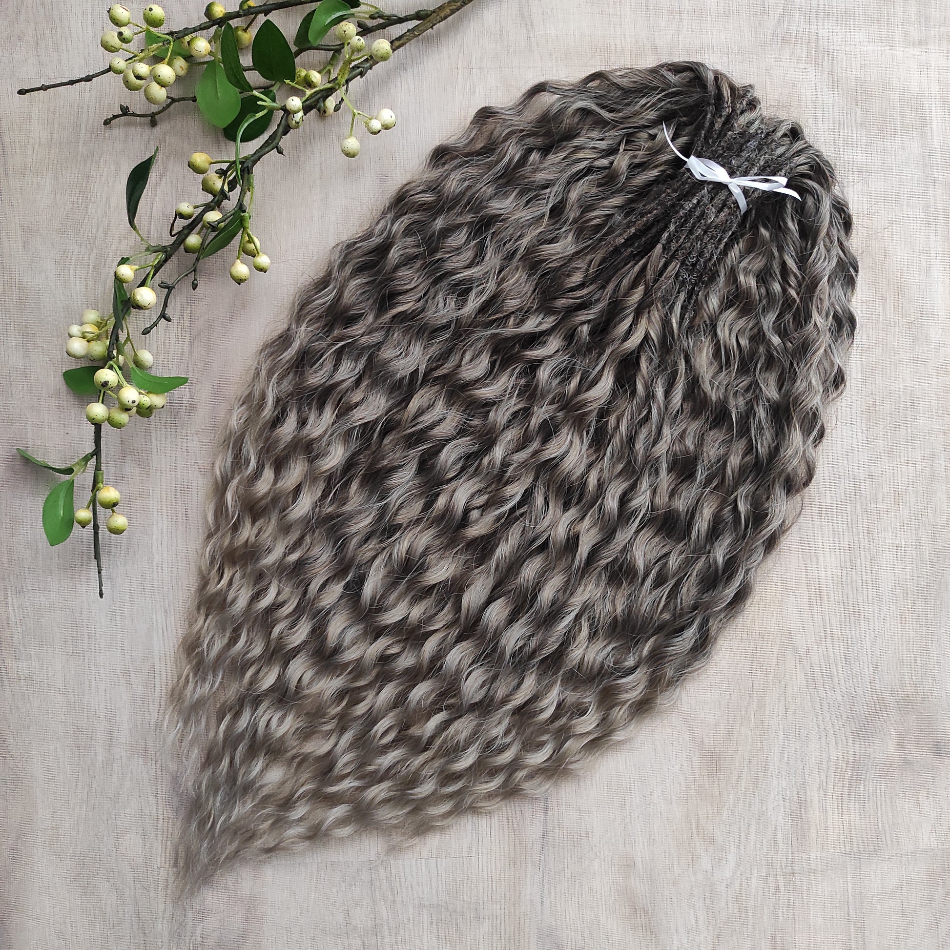 Ash ombre from light brown to wheat blonde (the color may look a bit different in different lighting). Soft, lightweight, and reusable synthetic brushable double ended wavy dreadlocks