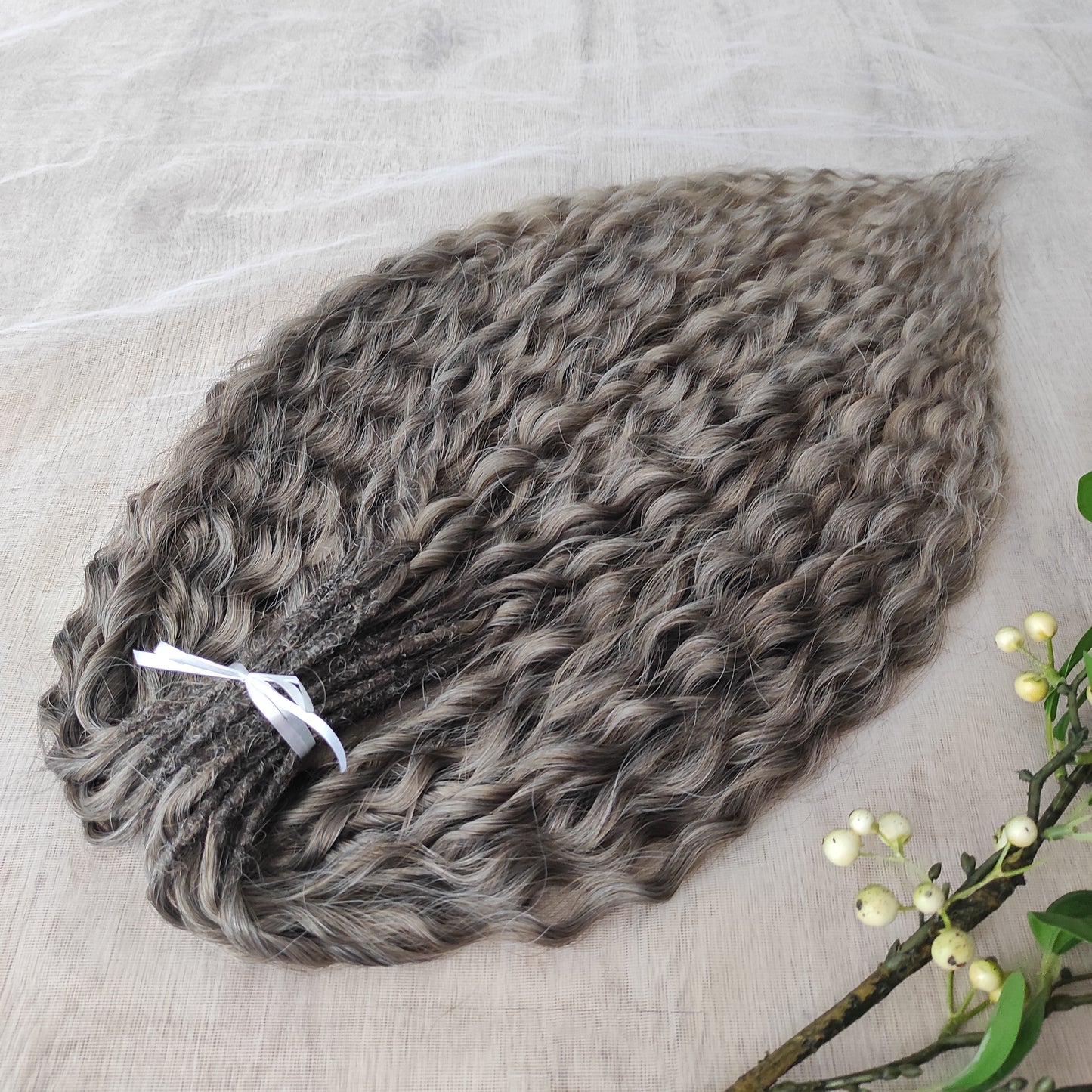 Ash ombre from light brown to wheat blonde (the color may look a bit different in different lighting). Soft, lightweight, and reusable synthetic brushable double ended wavy dreadlocks