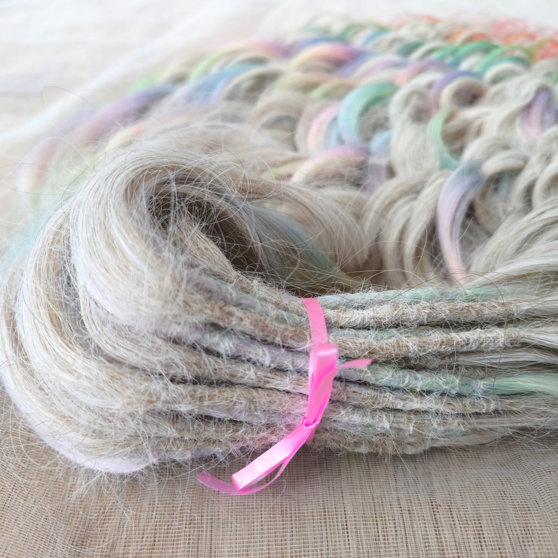 The mix of Platinum blonde and Rainbow/glitch/prism effect (2/3 parts of blonde + 1/3 part of rainbow) soft, lightweight, and reusable synthetic brushable double ended wavy dreadlocks (regular dreaded or push-up).