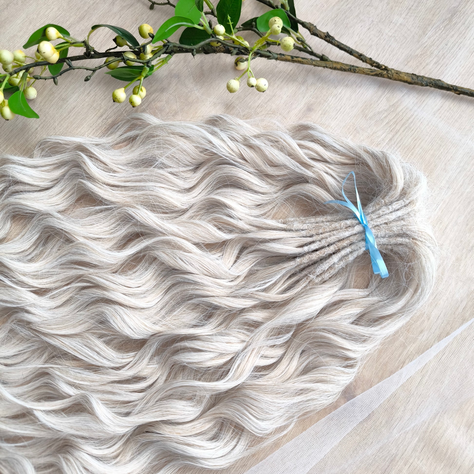 Platinum blonde soft, lightweight, and reusable synthetic brushable double ended wavy dreadlocks (regular dreaded, braided middle, or push-up).&nbsp;


The length:
Standard dreaded - 22-24 inches (55-60 cm), dreaded part ±4-5 inches
Braided middle - 22-24 inches (55-60 cm), braid ±4-5 inches folded (total ±8-10 inches)
Push-up / Dolly - 20-22 inches (50-55 cm), dreaded part ±4 inches (from working side)