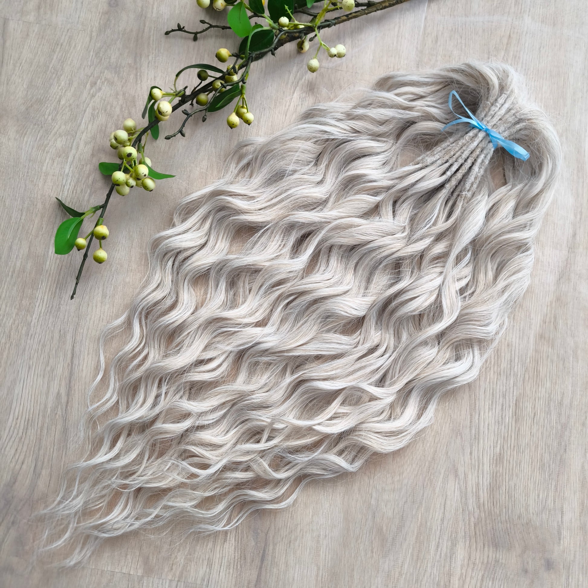 Platinum blonde soft, lightweight, and reusable synthetic brushable double ended wavy dreadlocks (regular dreaded, braided middle, or push-up).&nbsp;


The length:
Standard dreaded - 22-24 inches (55-60 cm), dreaded part ±4-5 inches
Braided middle - 22-24 inches (55-60 cm), braid ±4-5 inches folded (total ±8-10 inches)
Push-up / Dolly - 20-22 inches (50-55 cm), dreaded part ±4 inches (from working side)
