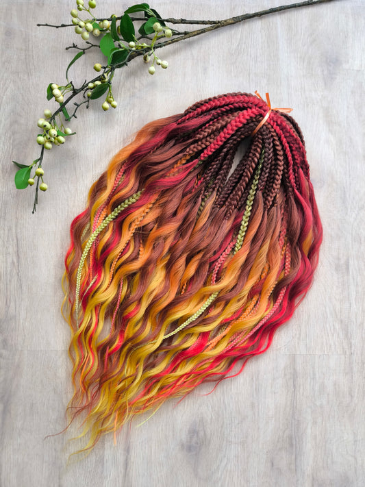 Mountain Sunrise: soft, lightweight, and reusable 55 double-ended synthetic braids with loose wavy brushable ends in red, bronze, yellow, and orange colors.