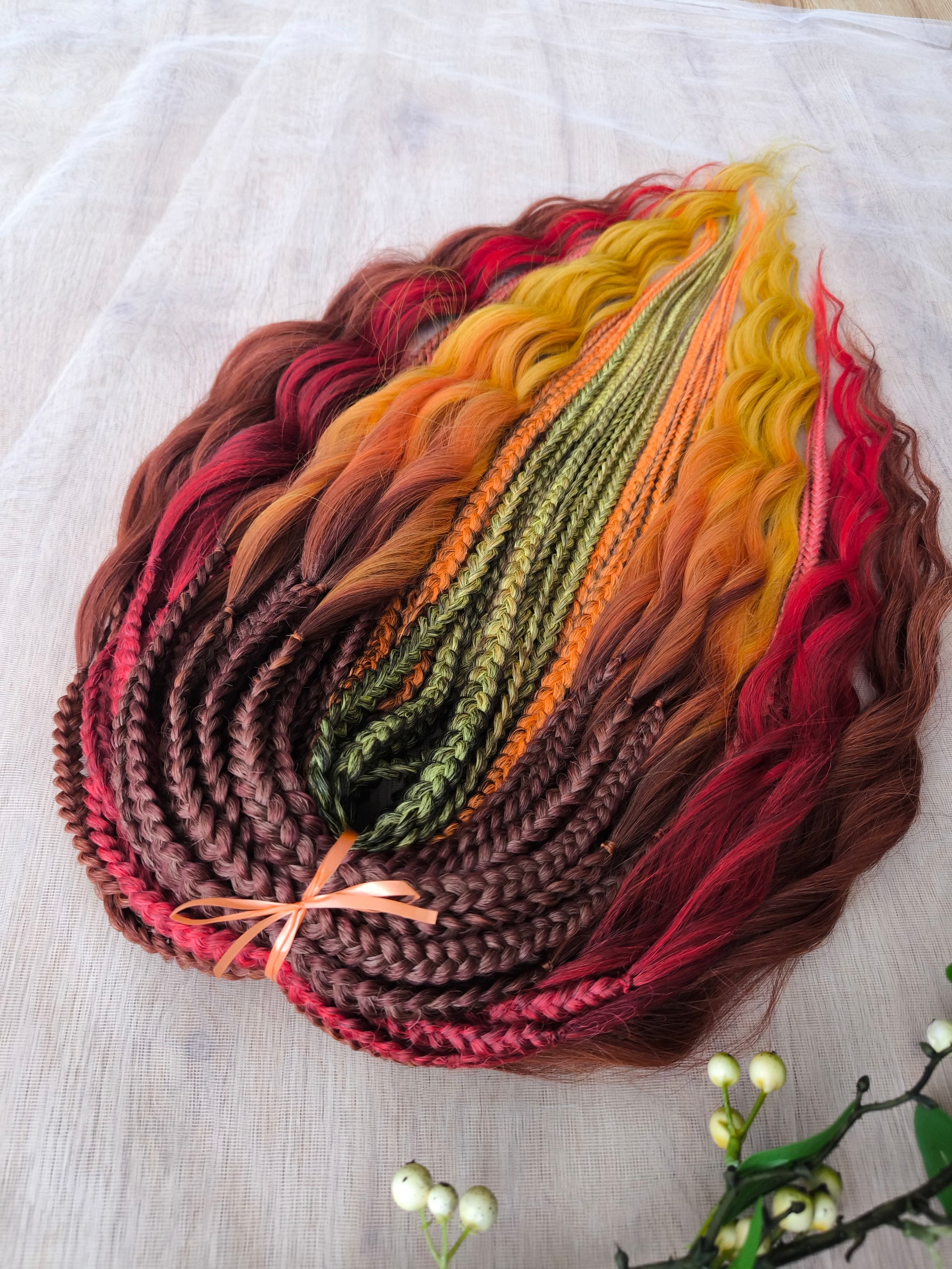 Mountain Sunrise: soft, lightweight, and reusable 55 double-ended synthetic braids with loose wavy brushable ends in red, bronze, yellow, and orange colors.