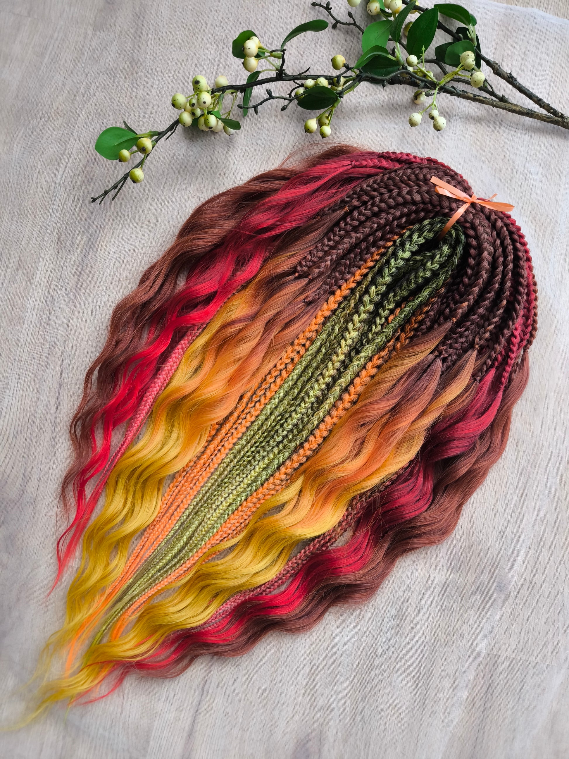 Mountain Sunrise: soft, lightweight, and reusable 55 double-ended synthetic braids with loose wavy brushable ends in red, bronze, yellow, and orange colors.