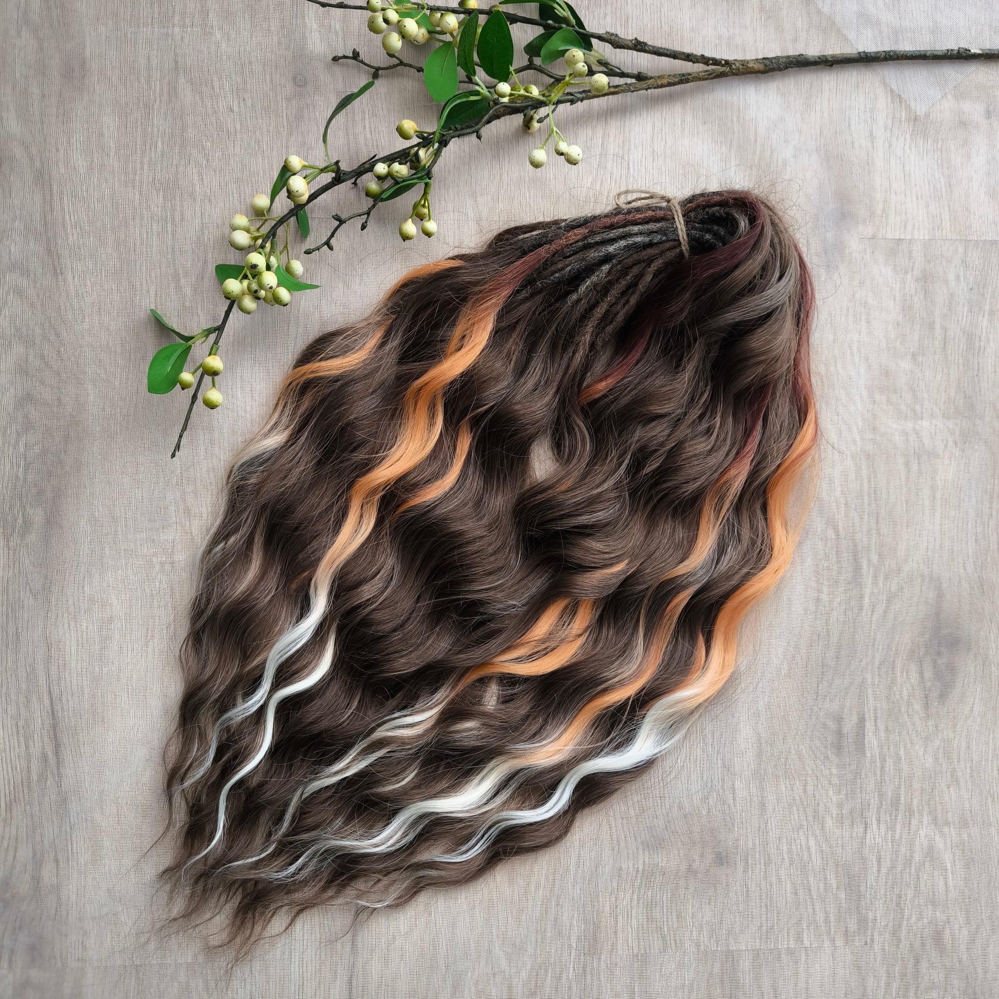 This moody, elegant set of soft, lightweight, and reusable synthetic brushable double-ended wavy dreadlocks features 2 shades of brown as the main color, enriched with calico strands. 