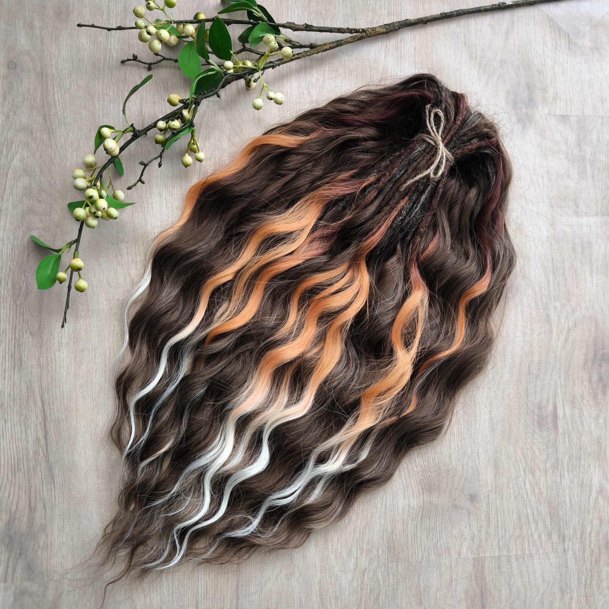 This moody, elegant set of soft, lightweight, and reusable synthetic brushable double-ended wavy dreadlocks features 2 shades of brown as the main color, enriched with calico strands. 