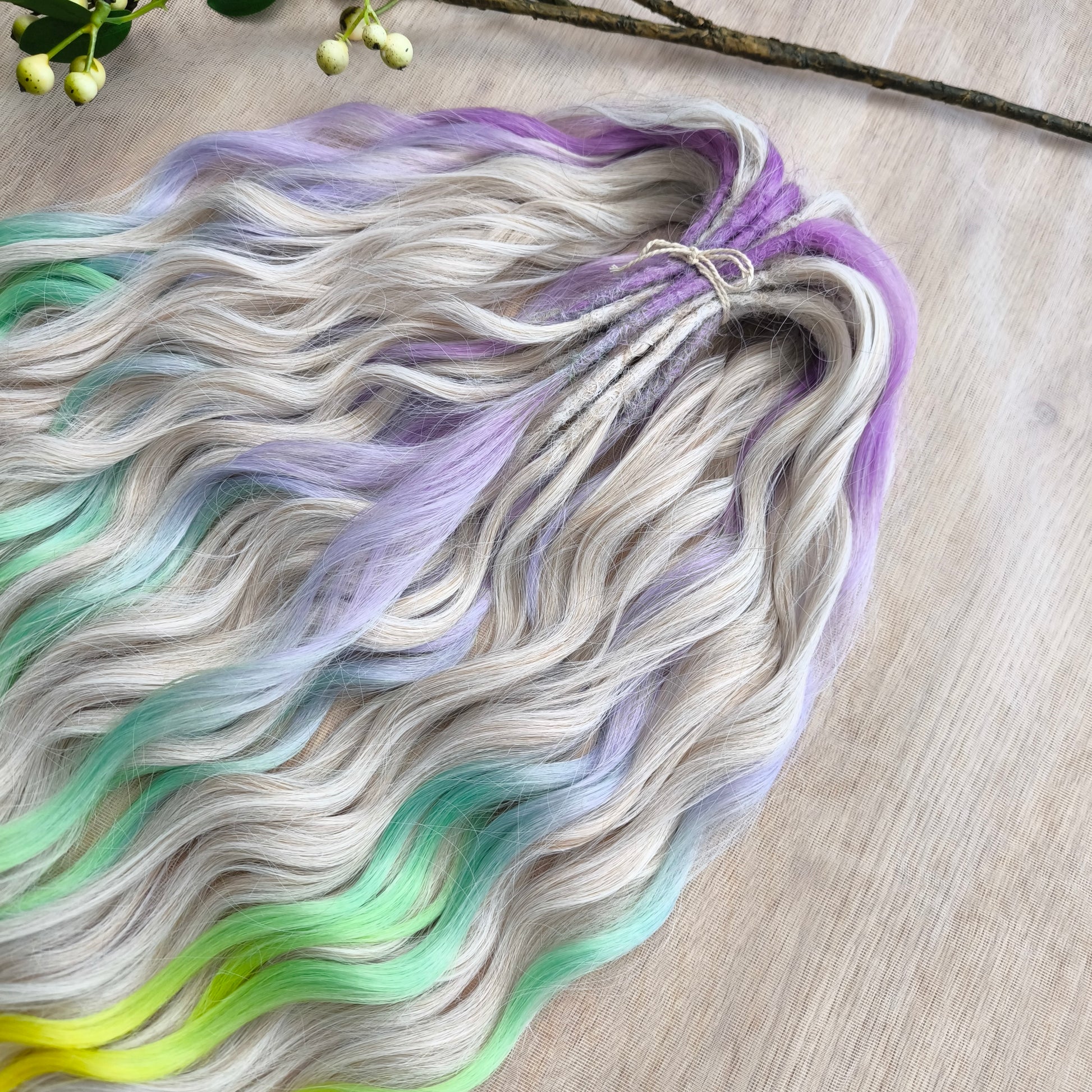 The mix of Platinum Blonde and Multicolored ombre from purple/lavender to light green and yellow soft, lightweight, and reusable synthetic brushable double ended wavy dreadlocks (regular dreaded or push-up): 2/3 parts of blonde + 1/3 part of rainbow