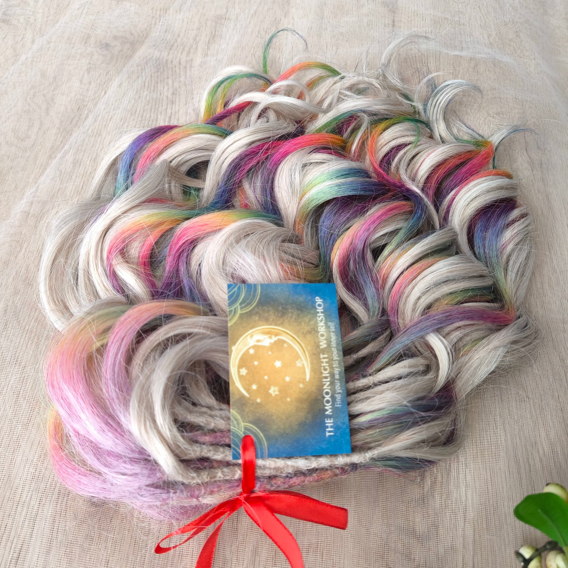 White Rainbow - 60 DE soft, lightweight, and reusable synthetic standard dreaded brushable curls Manasi. Platinum blonde base blended with rainbow/prism/glitch effect accents. 

Length: 16 inches (40 cm)
Dreaded part: approximately 3-4 inches (8-10 cm)
Weight: ±300 gr (10,6 oz)