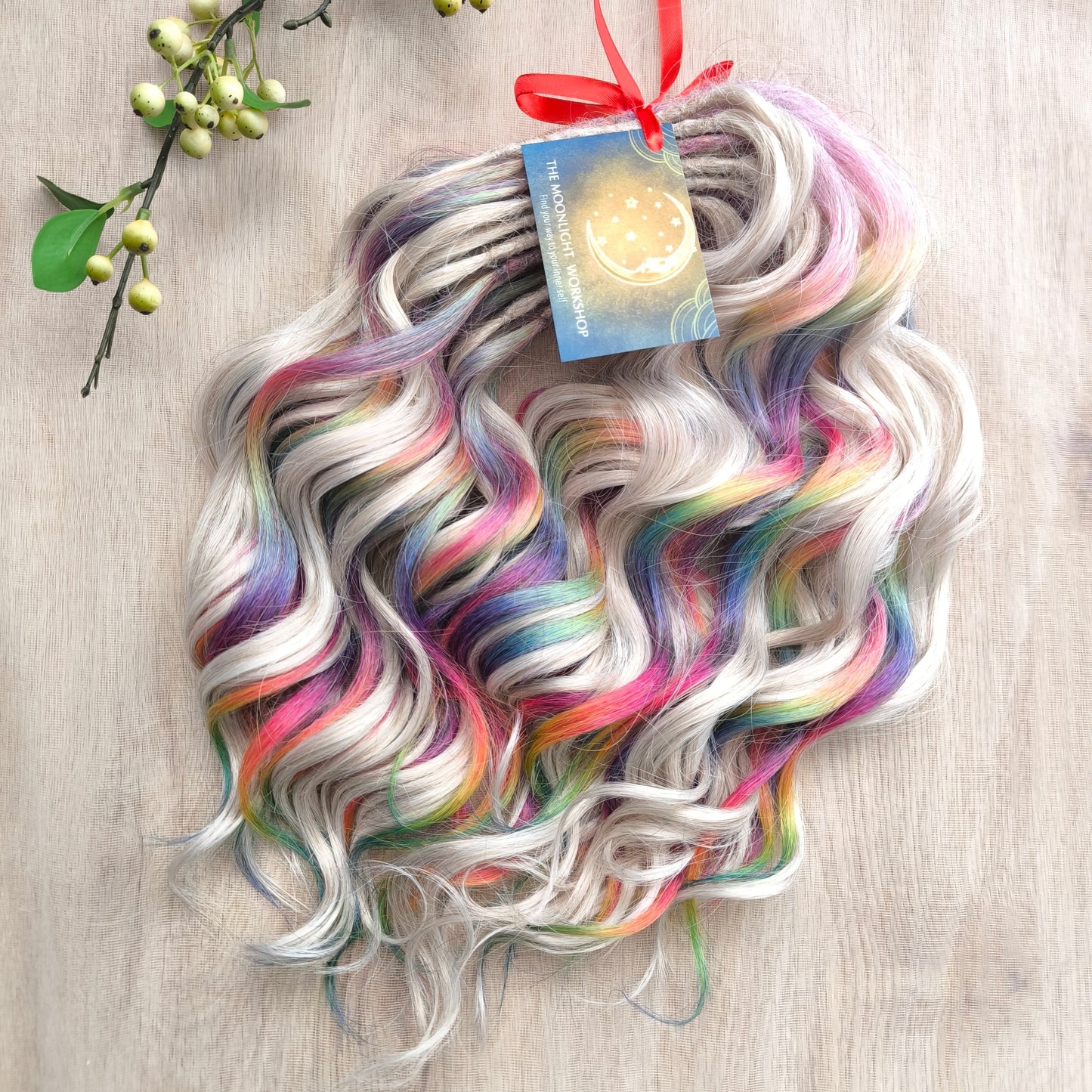 White Rainbow - 60 DE soft, lightweight, and reusable synthetic standard dreaded brushable curls Manasi. Platinum blonde base blended with rainbow/prism/glitch effect accents. 

Length: 16 inches (40 cm)
Dreaded part: approximately 3-4 inches (8-10 cm)
Weight: ±300 gr (10,6 oz)