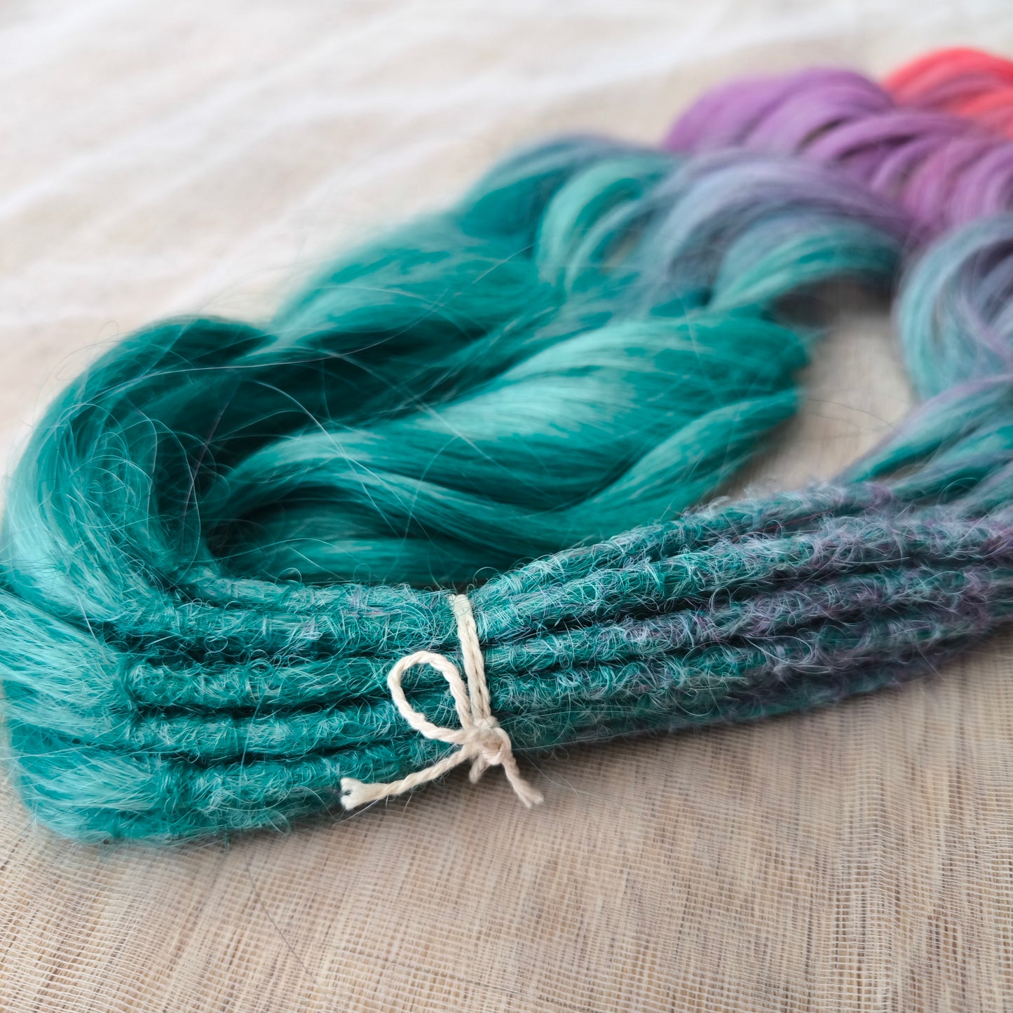 Colorful Rainbow prism (ombre from green to purple and red), soft, lightweight, and reusable synthetic sets of wavy double ended brushable dreadlocks.