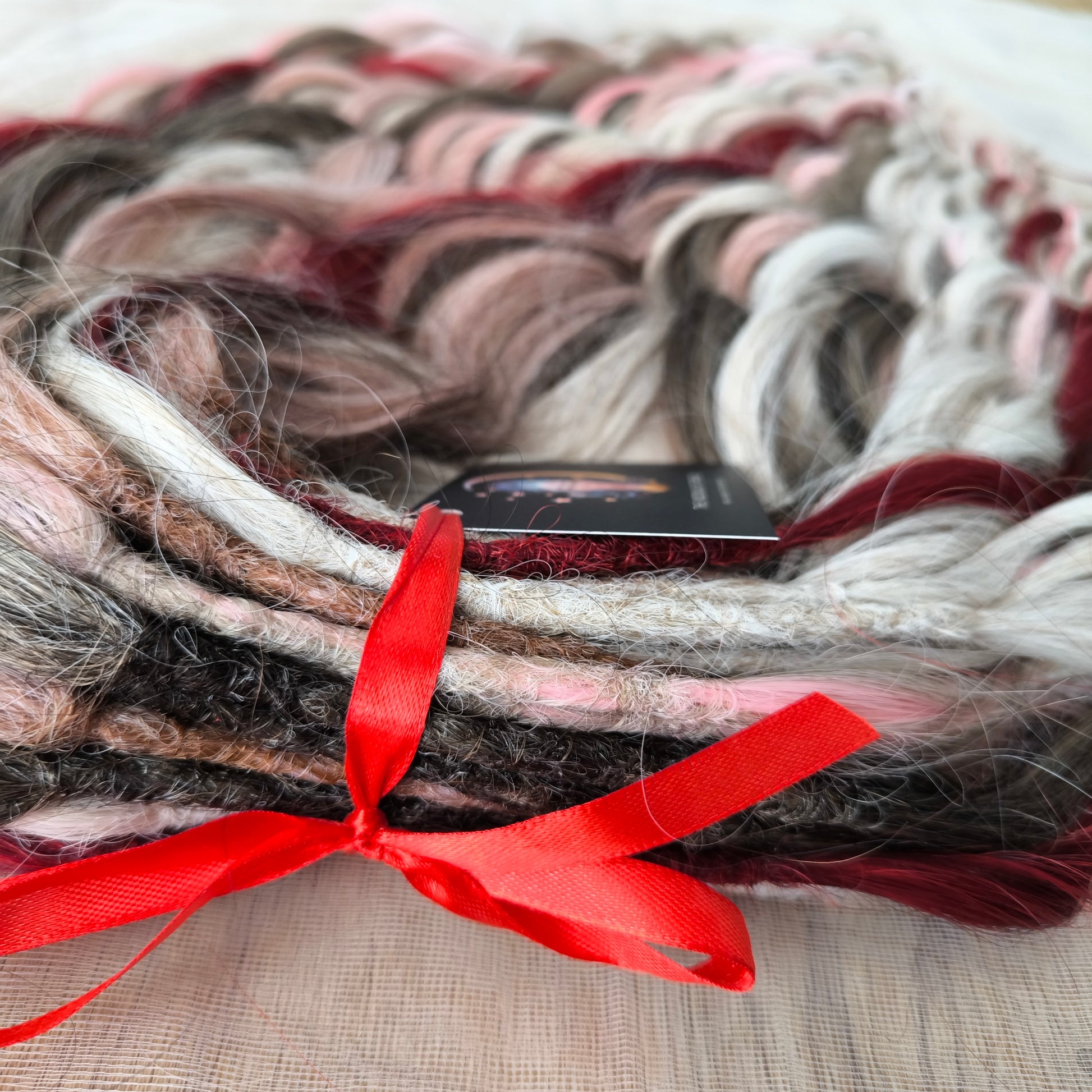 Soft, lightweight, and reusable synthetic brushable double ended wavy dreadlocks (regular dreaded or push-up). Mix of a few colors: platinum and ombre wheat blondes, various pink, and burgundy.