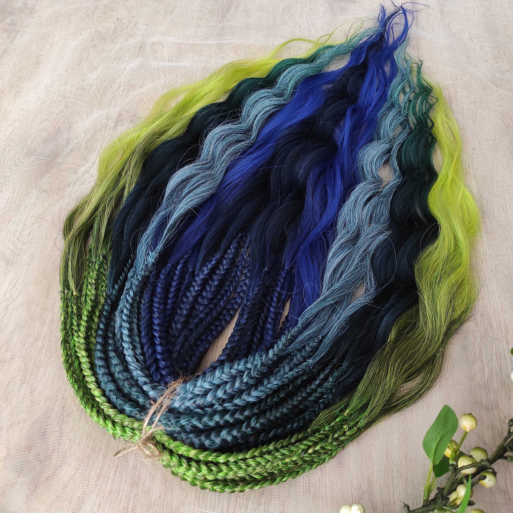 Inspired by the feathers of a peacock and the magic of the deep forest, this set blends rich navy, electric blue, moss green, lime, and seafoam in an eye-catching gradient. Whether you're stepping into a festival or simply expressing your wild side, this look makes a powerful statement.

Soft, lightweight, and reusable synthetic brushable double ended wavy dreadlocks, a mix of Anna and Body wave with braided middle.