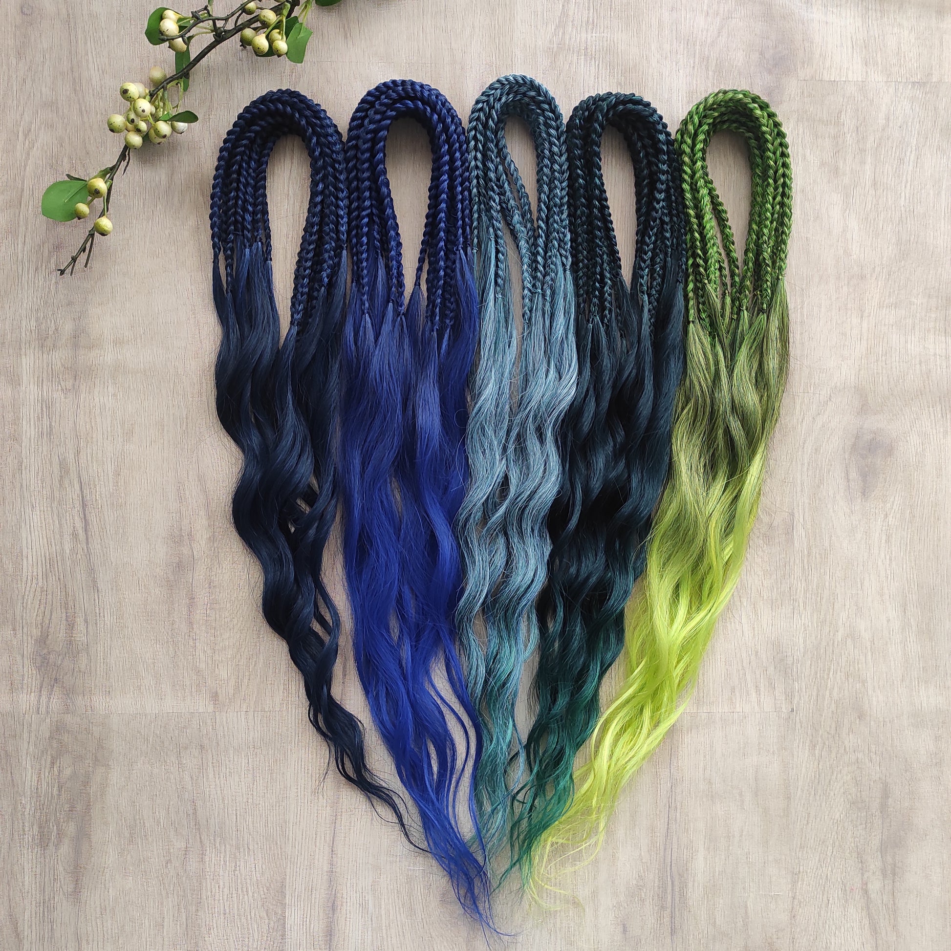 Inspired by the feathers of a peacock and the magic of the deep forest, this set blends rich navy, electric blue, moss green, lime, and seafoam in an eye-catching gradient. Whether you're stepping into a festival or simply expressing your wild side, this look makes a powerful statement.

Soft, lightweight, and reusable synthetic brushable double ended wavy dreadlocks, a mix of Anna and Body wave with braided middle.