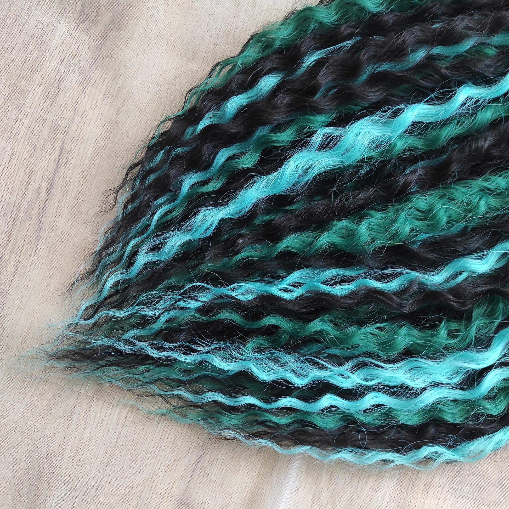 Midnight Tide - a deep mix of almost-black brown, emerald green, and teal/aqua green - dark, rich, and full of depth. Soft, lightweight, and reusable synthetic double ended NON-BRUSHABLE curls.