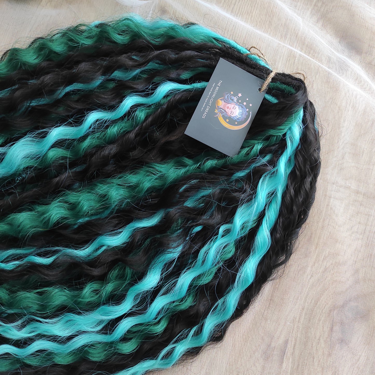 Midnight Tide - a deep mix of almost-black brown, emerald green, and teal/aqua green - dark, rich, and full of depth. Soft, lightweight, and reusable synthetic double ended NON-BRUSHABLE curls.